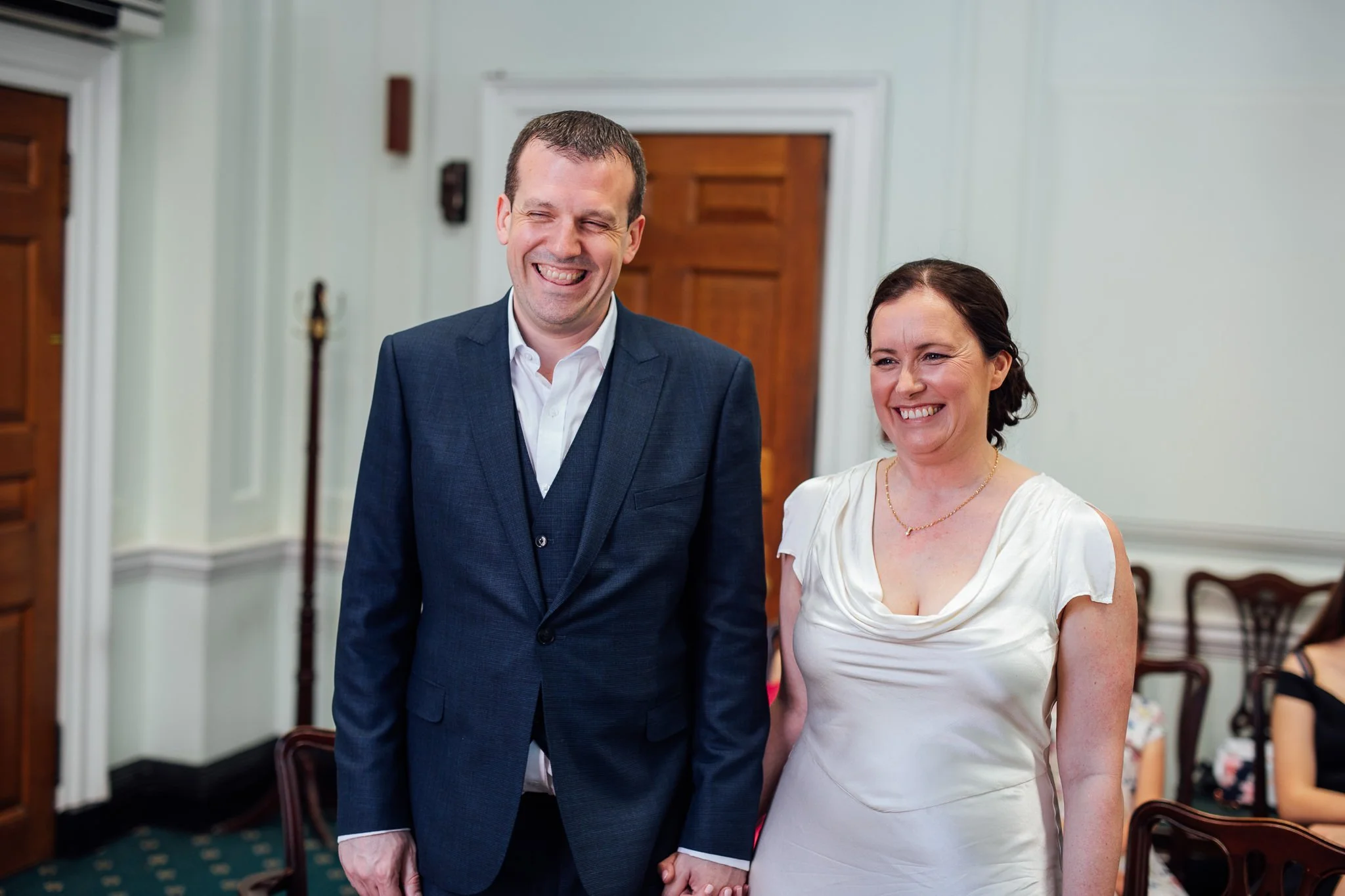 Bride and Groom smiling during their ceremony at Camden Town Hall 