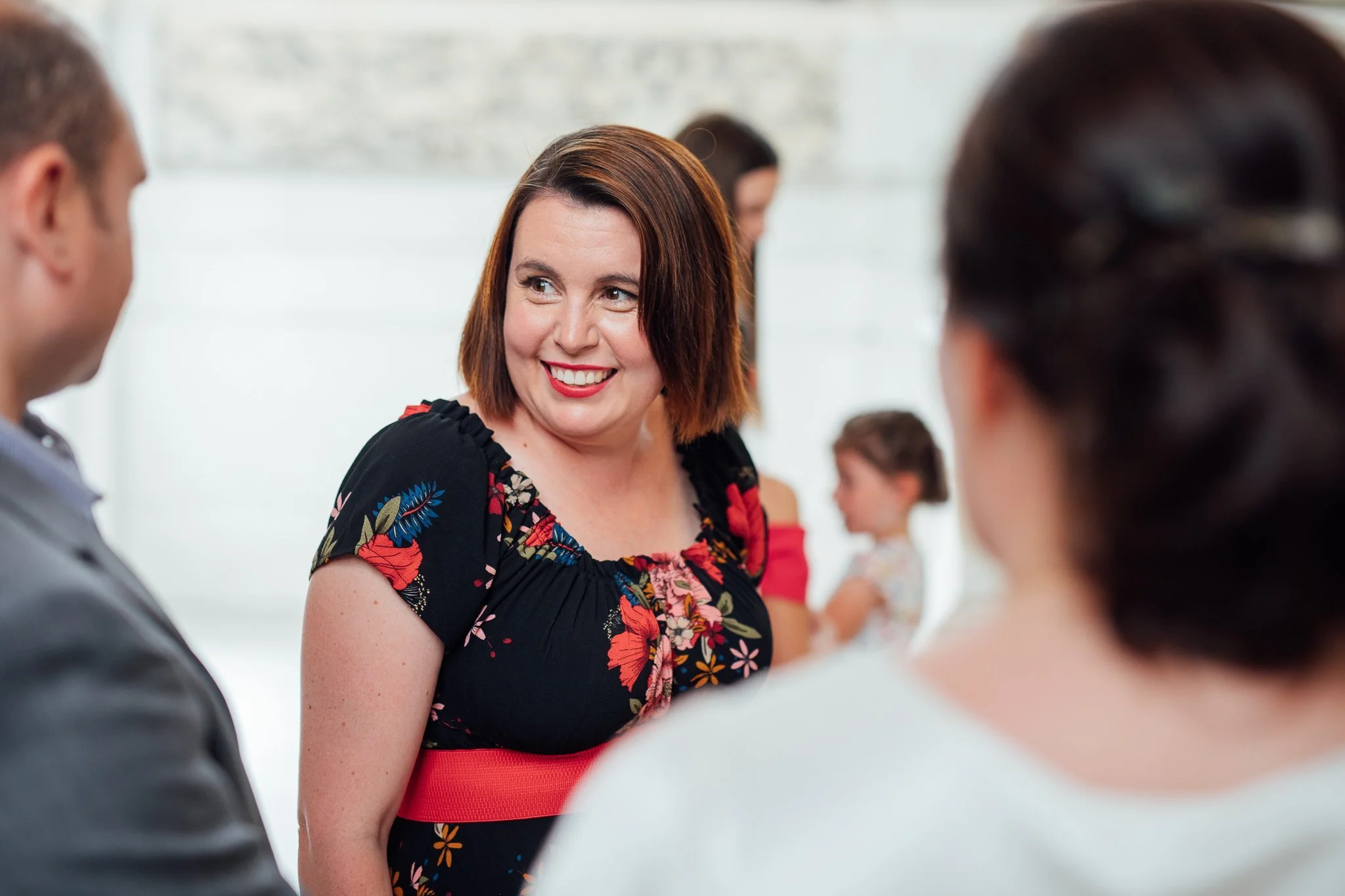  Female wedding guest smiling  
