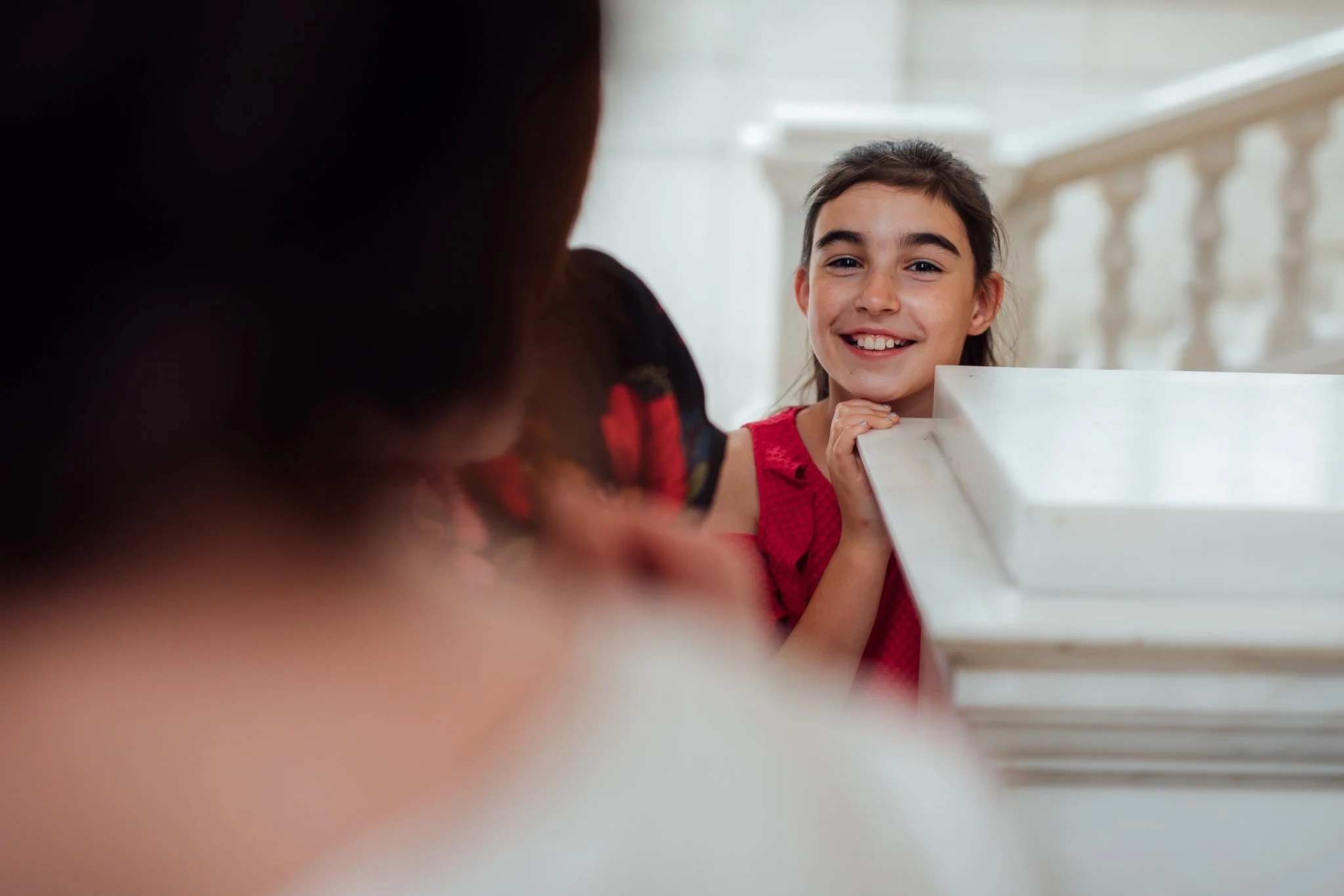  Young wedding guest smiling at Camden Town Hall 