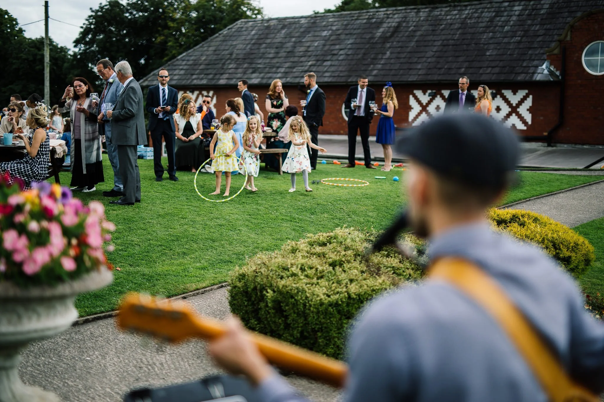  Children playing with toys in front of a musician  
