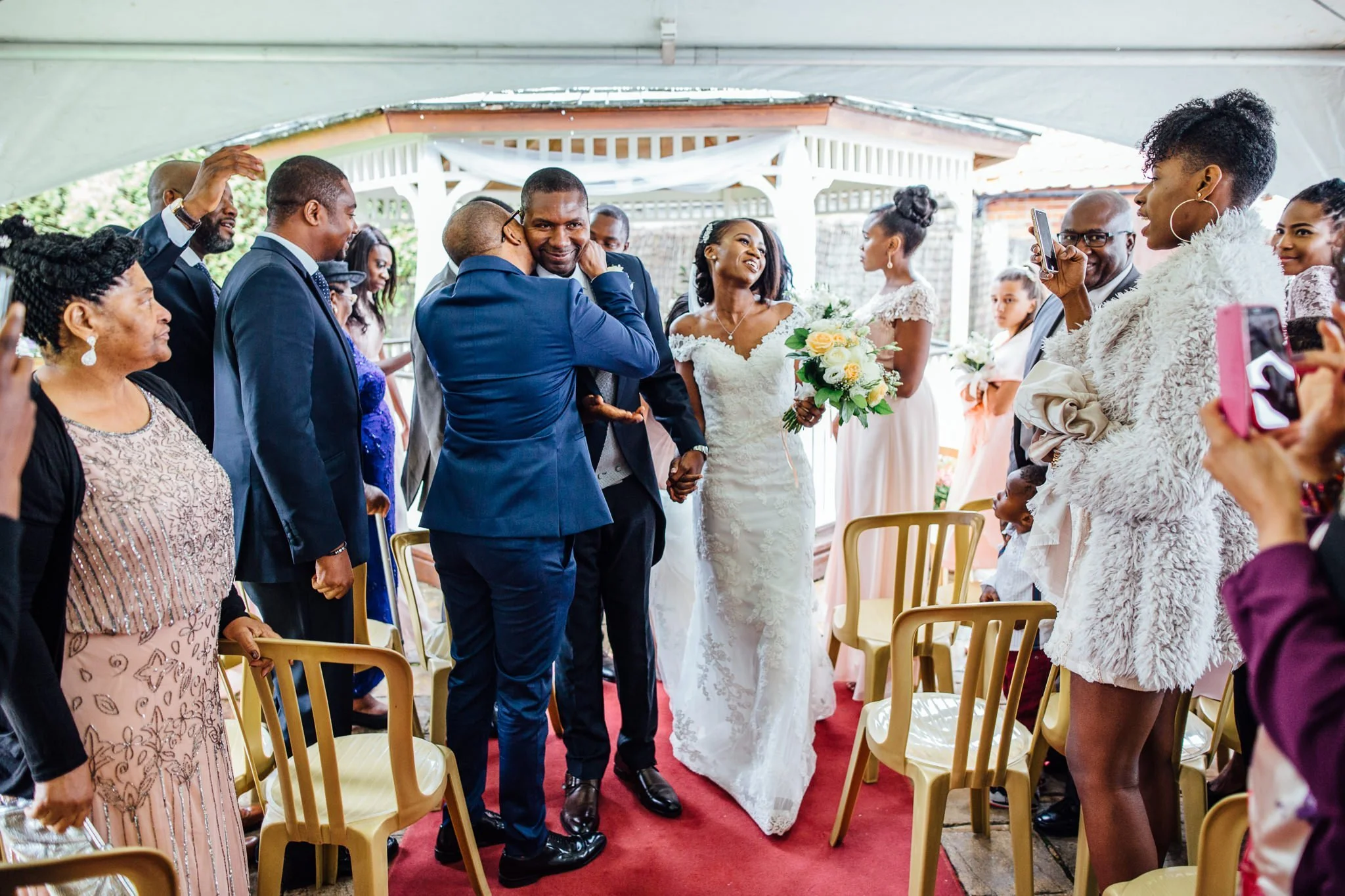 Bride and groom walk down the aisle after being married at Newland Hall Essex 