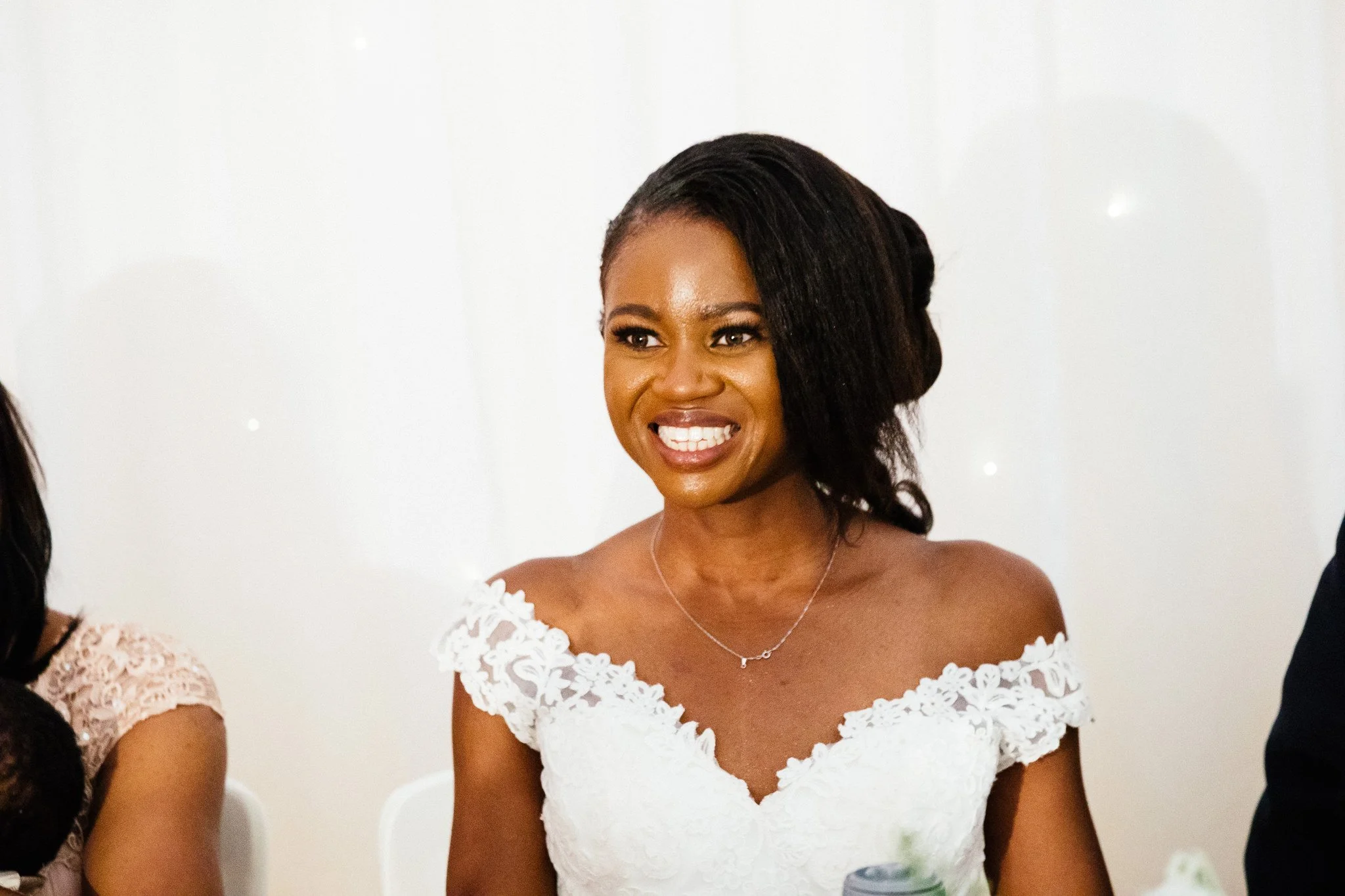  Bride smiling during the speeches at Newland Hall Essex 
