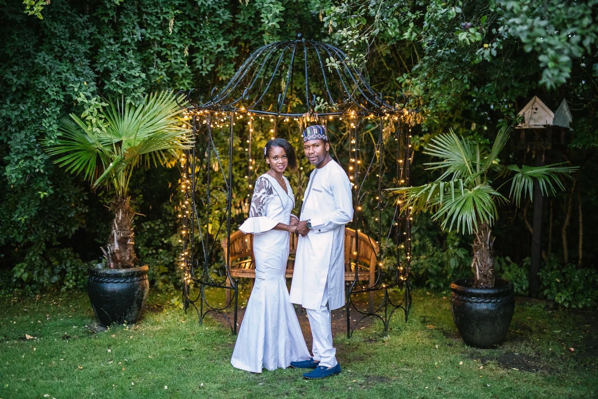  Bride and Groom pose for a picture on the grounds of Newland Hall Essex in their traditional Nigerian attire 