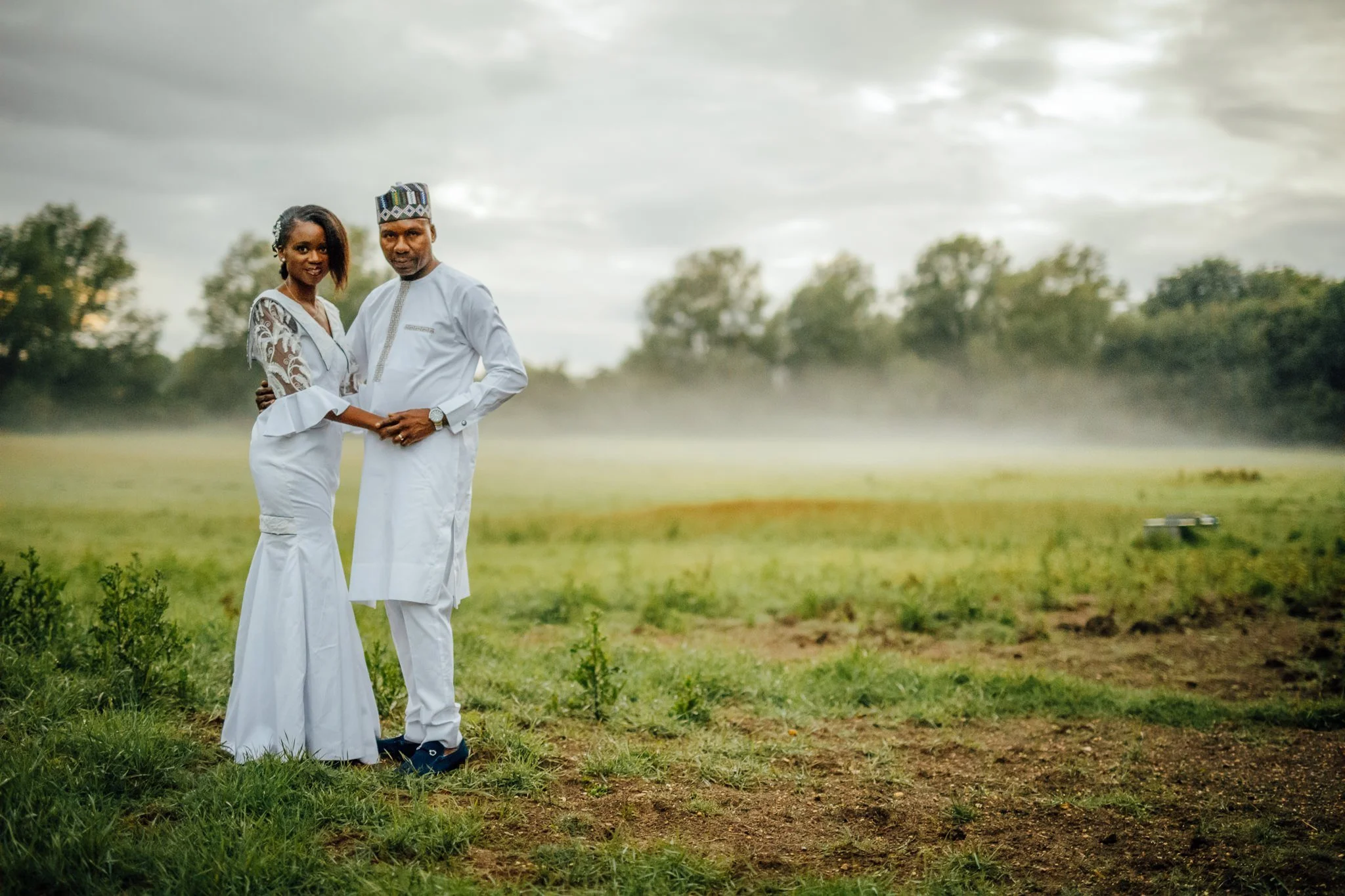  Bride and Groom as the sun sets with mist behind them at Newland Hall Essex 