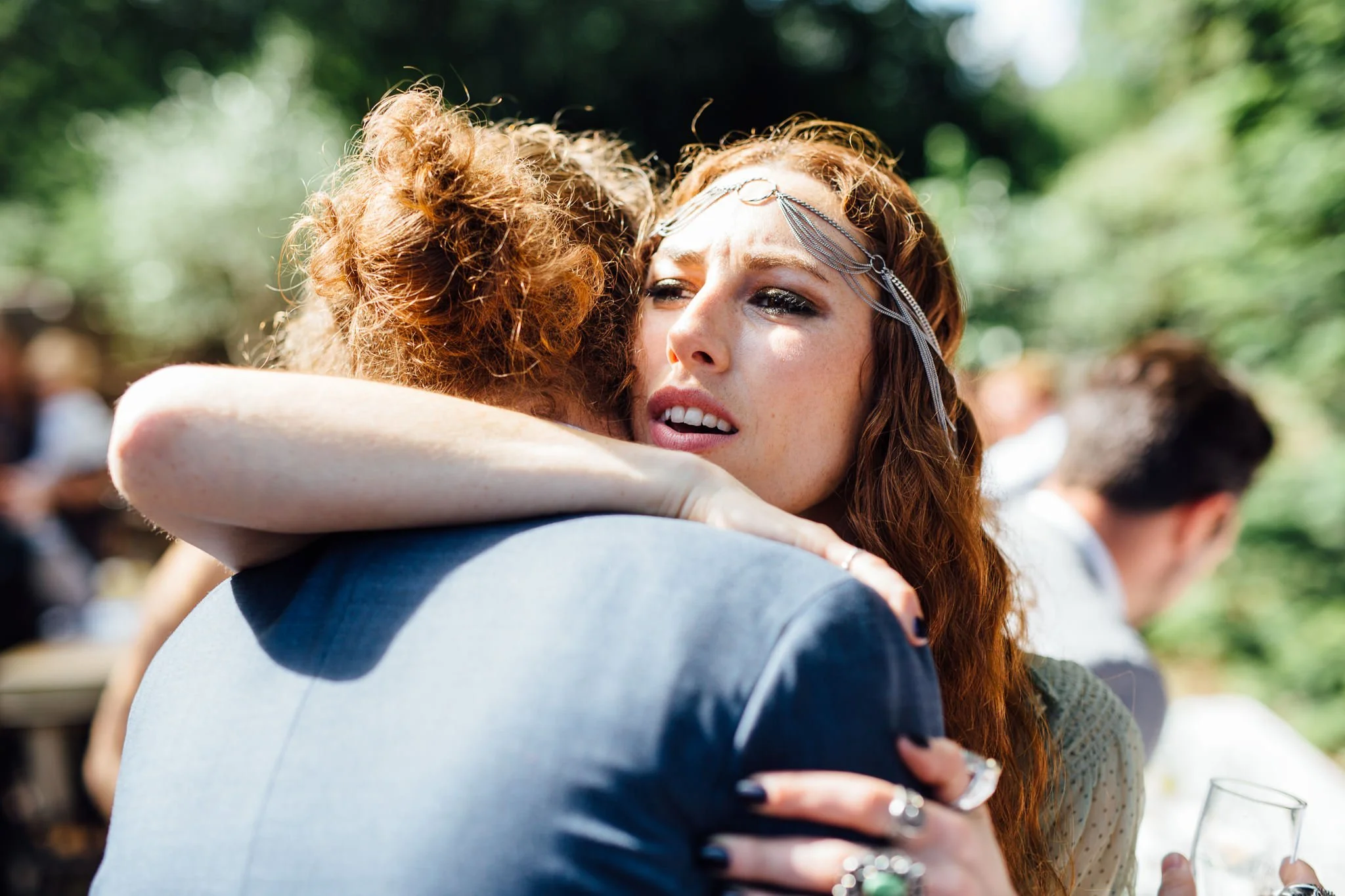  Attractive female guest hugs the groom 