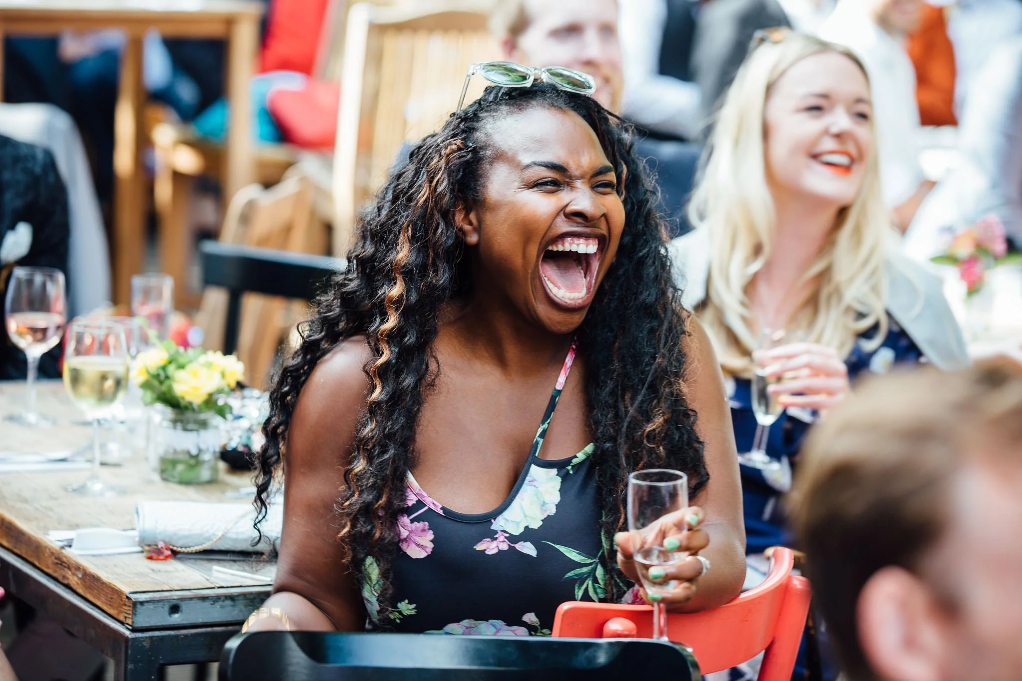  Female wedding guest laughs 