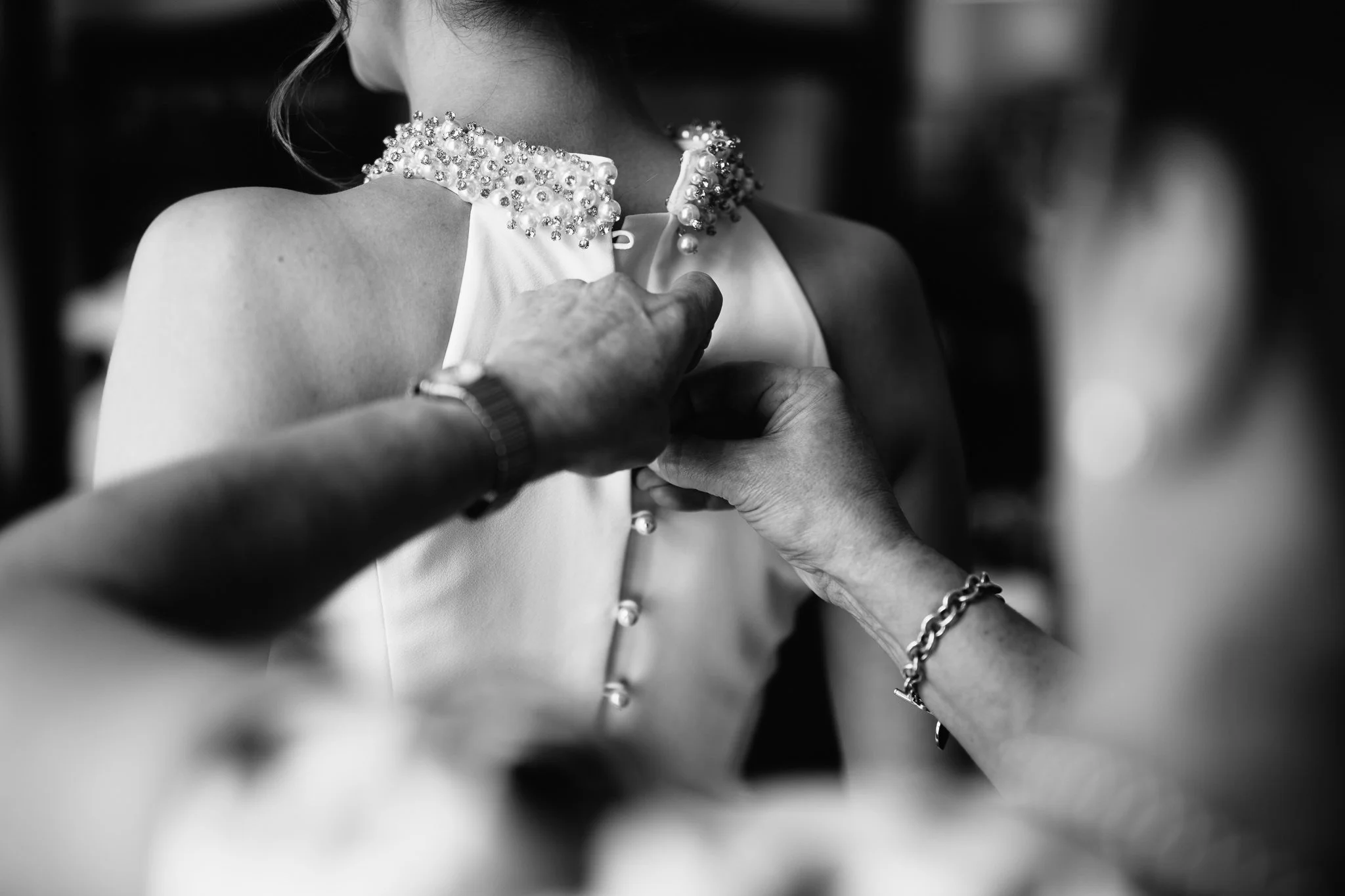  Bride has back of her dress done up at The Kensington Hotel 