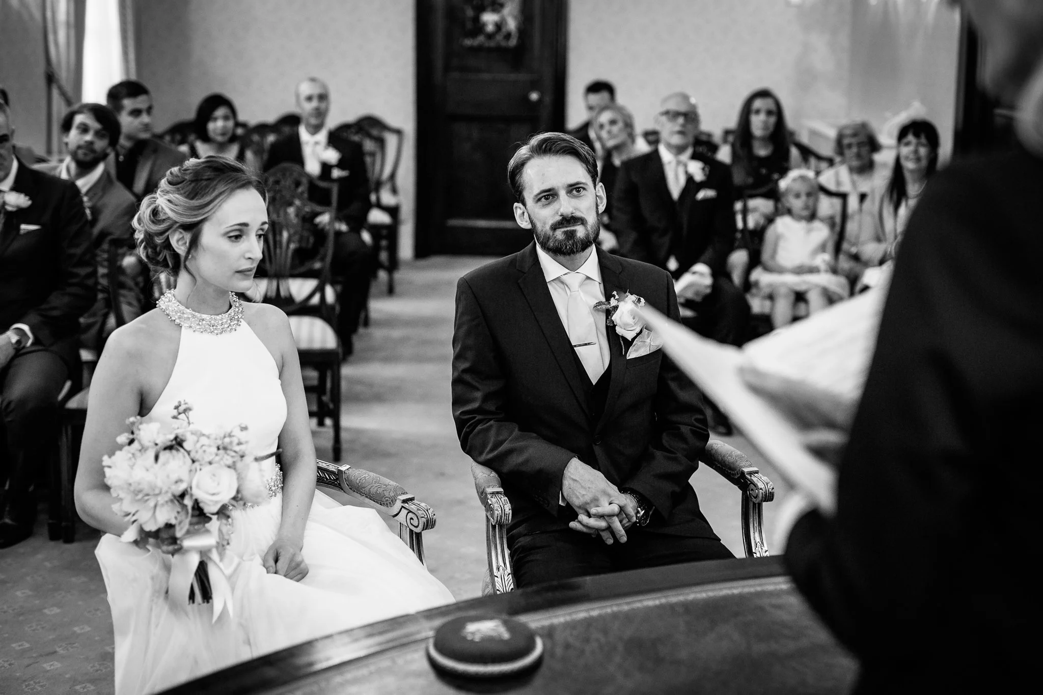  Bride and Groom listen to registrar at Chelsea Old Town Hall 