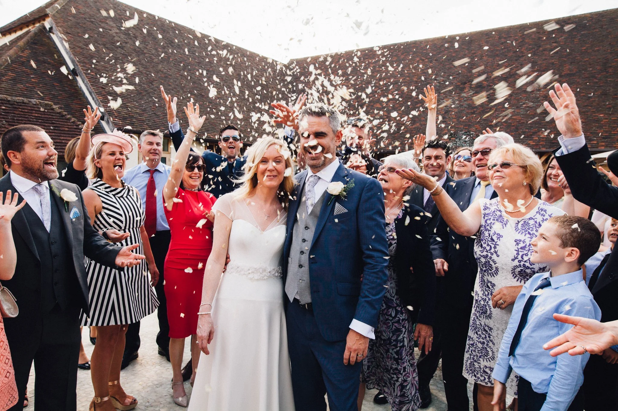  Wedding guests throw confetti at Bride and Groom at Rivervale Barn 