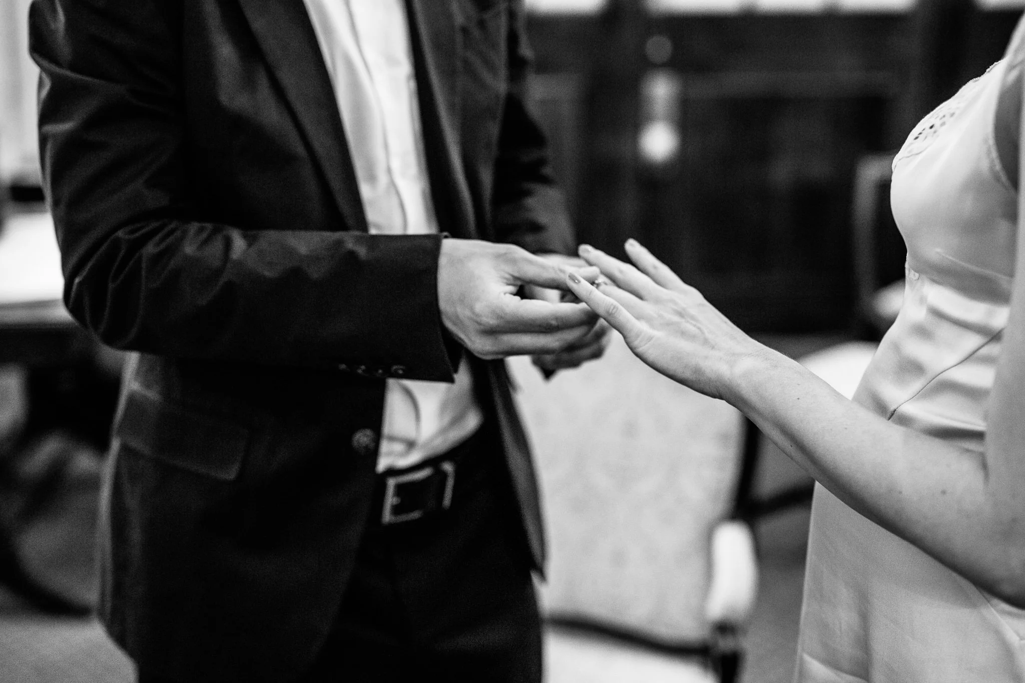  Groom puts the ring on the finger of the bride at Chelsea Old Town Hall 