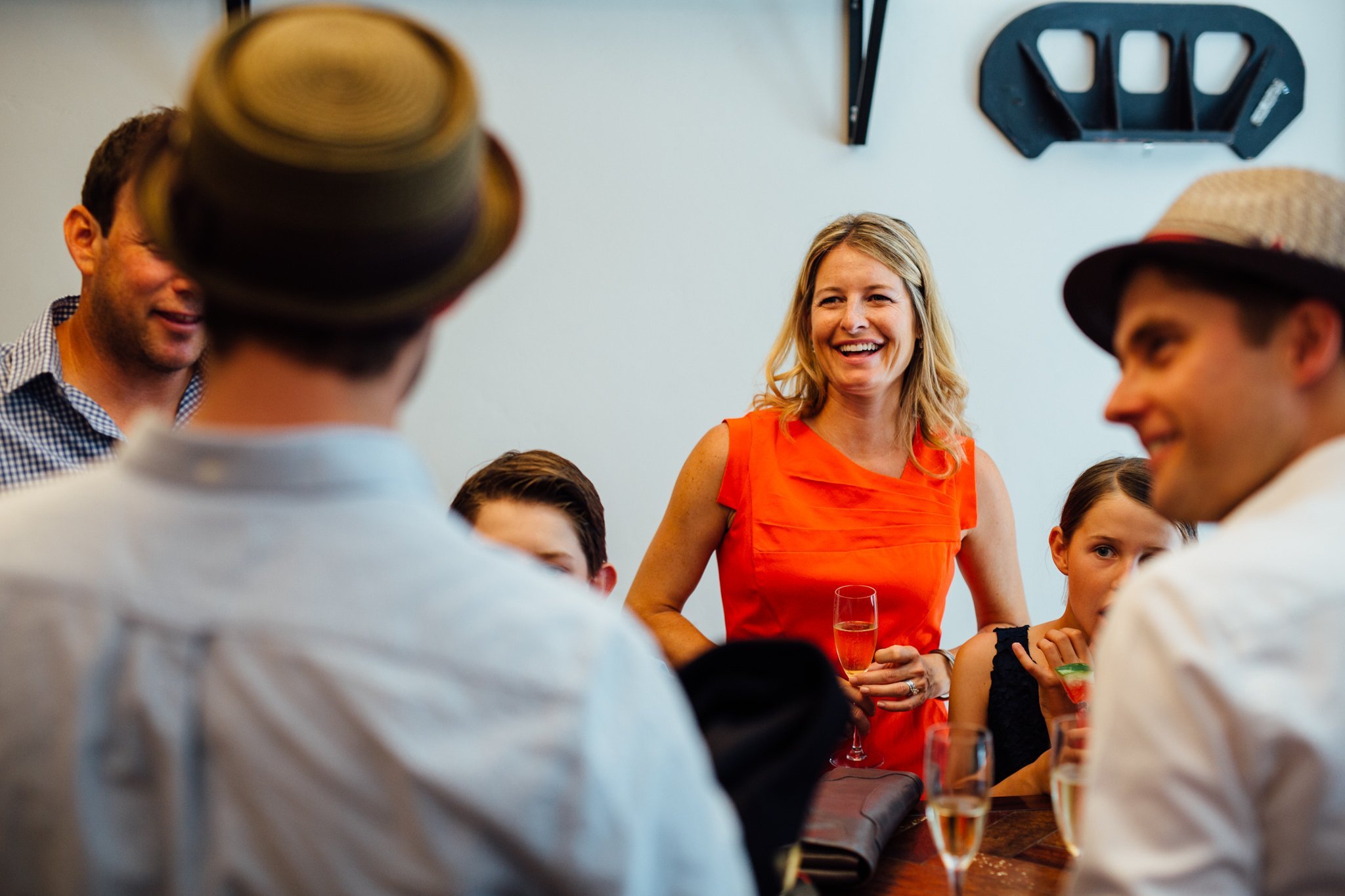  Female wedding guest smiling in a red dress 