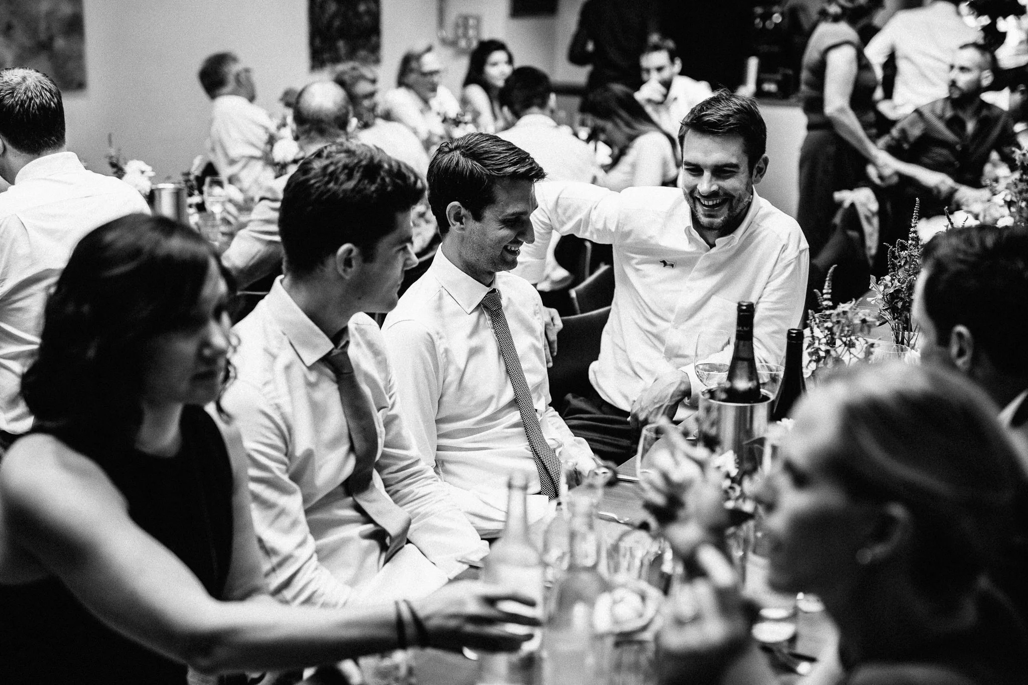  Groom talking to friends during the wedding breakfast 