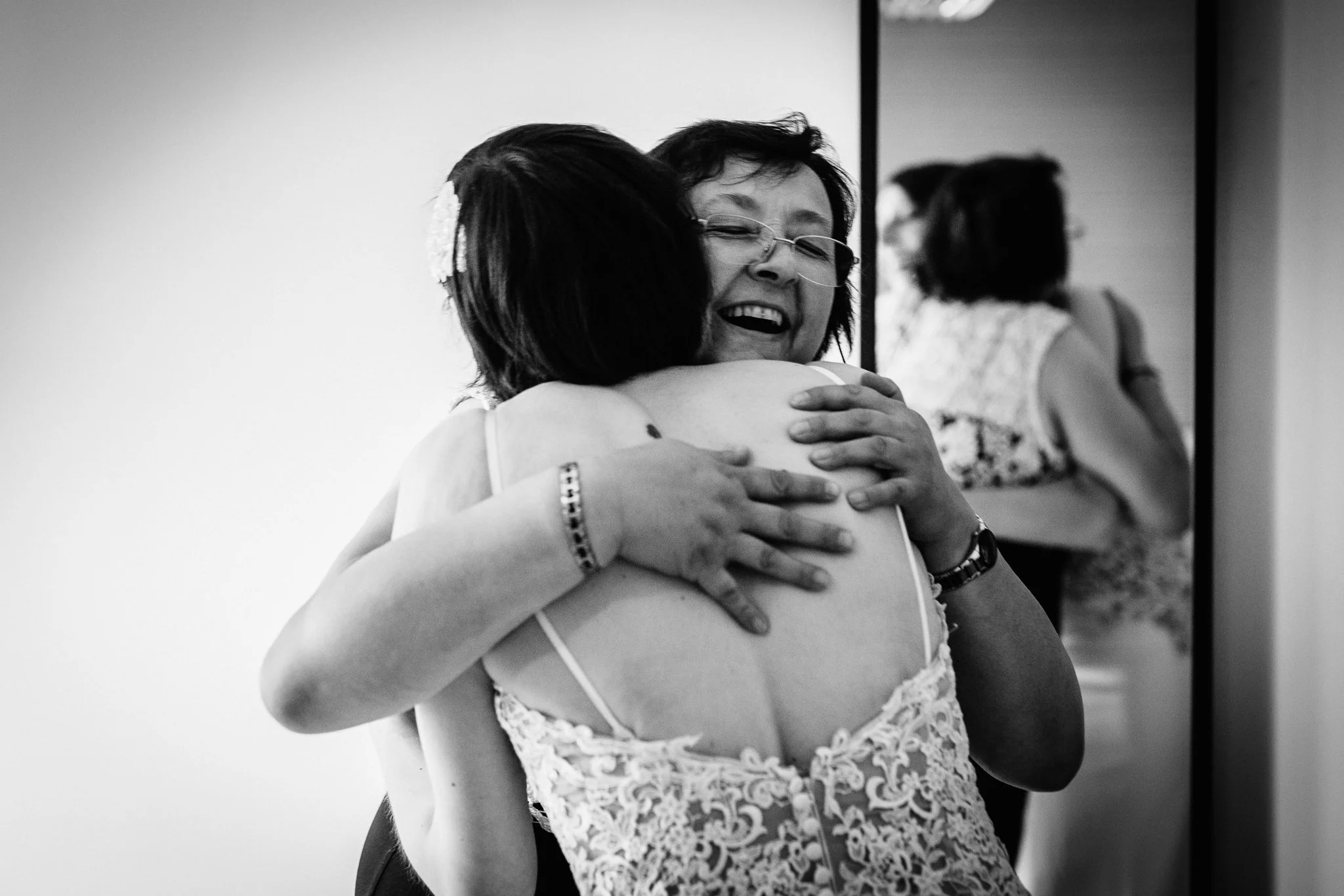 Mother of the bride hugging the bride 