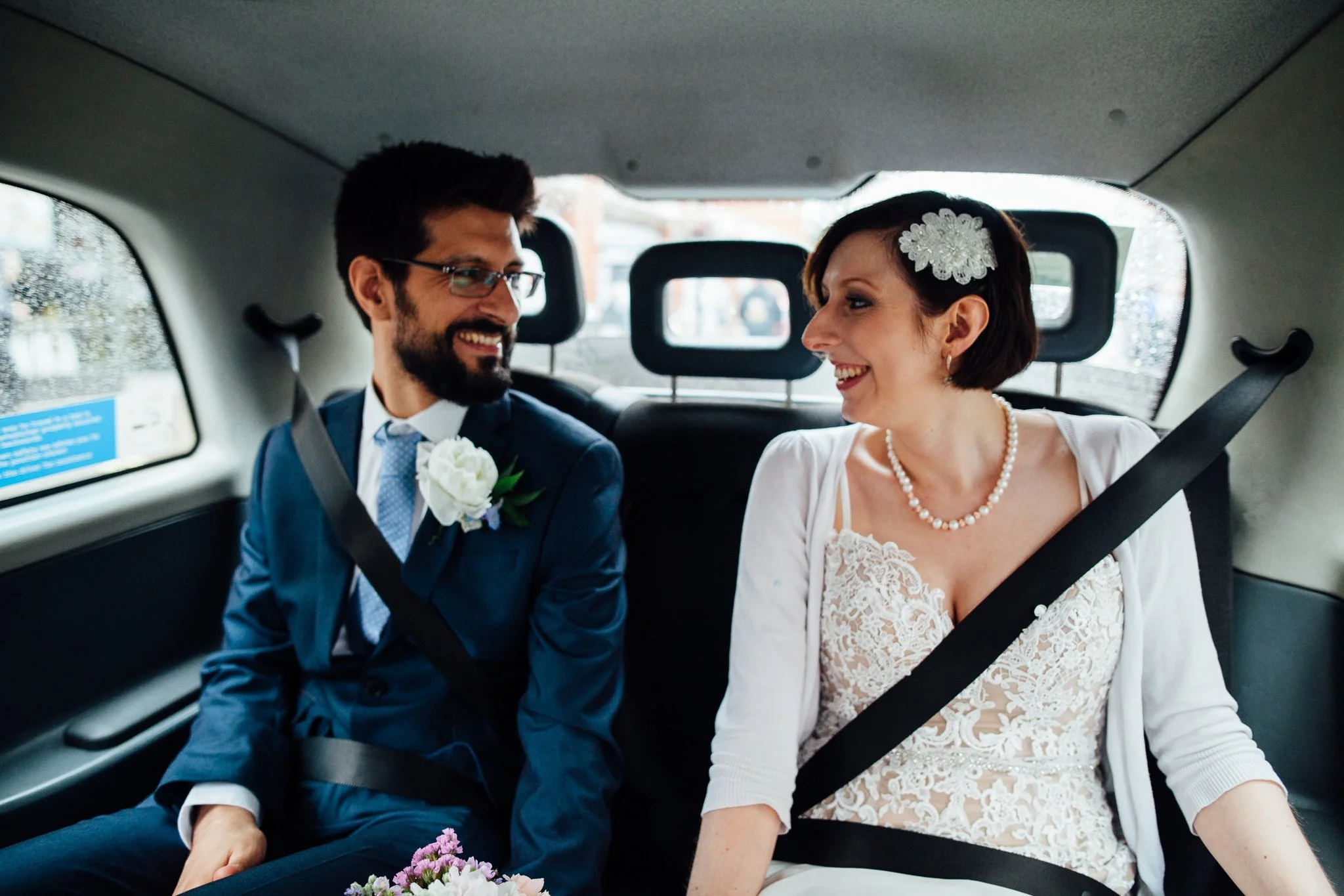  Bride and Groom in a taxi on the way to Camden Town Hall 