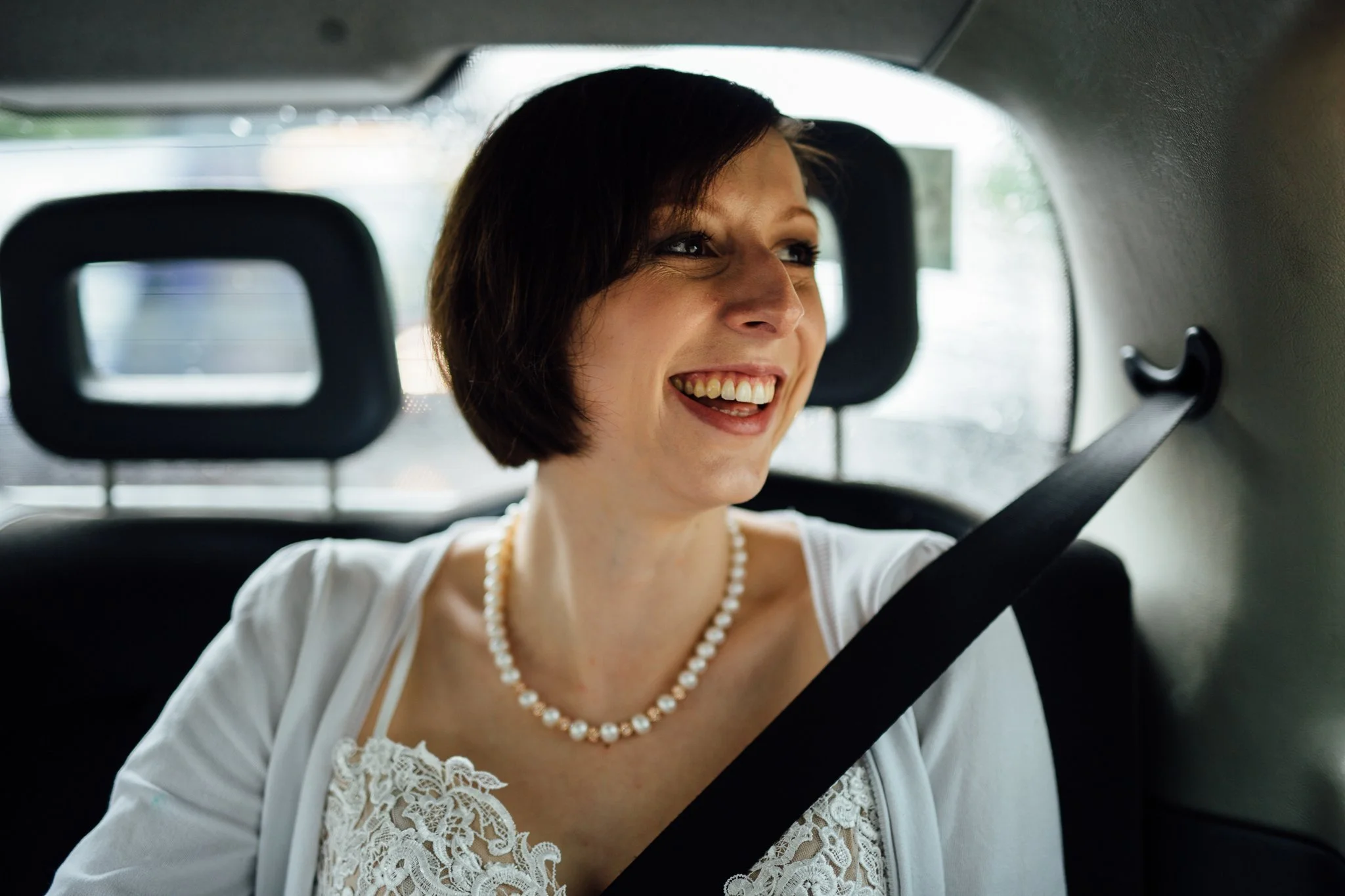  Bride smiling in a taxi 