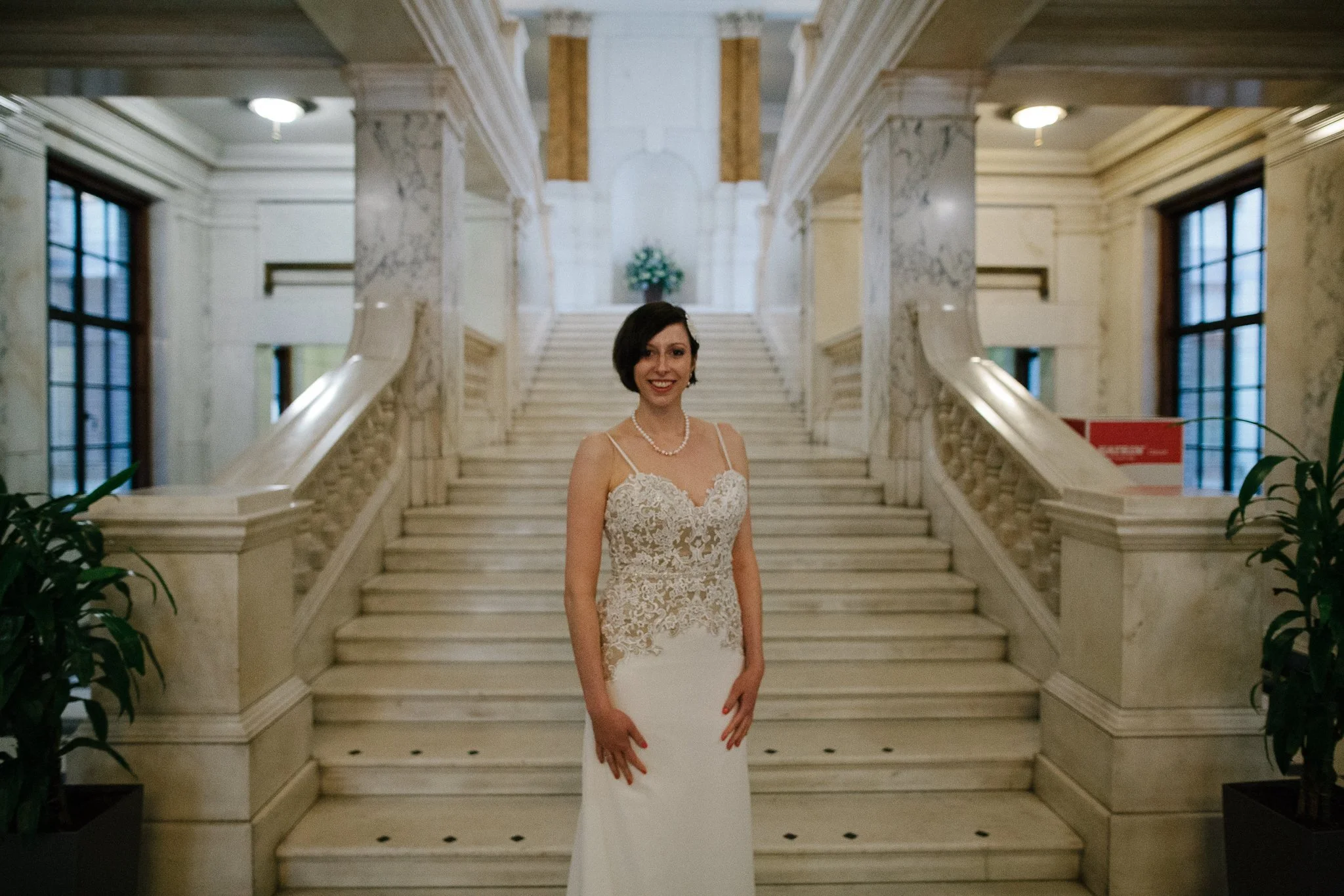  Bride standing at the bottom of the stairs in Camden Town Hall 