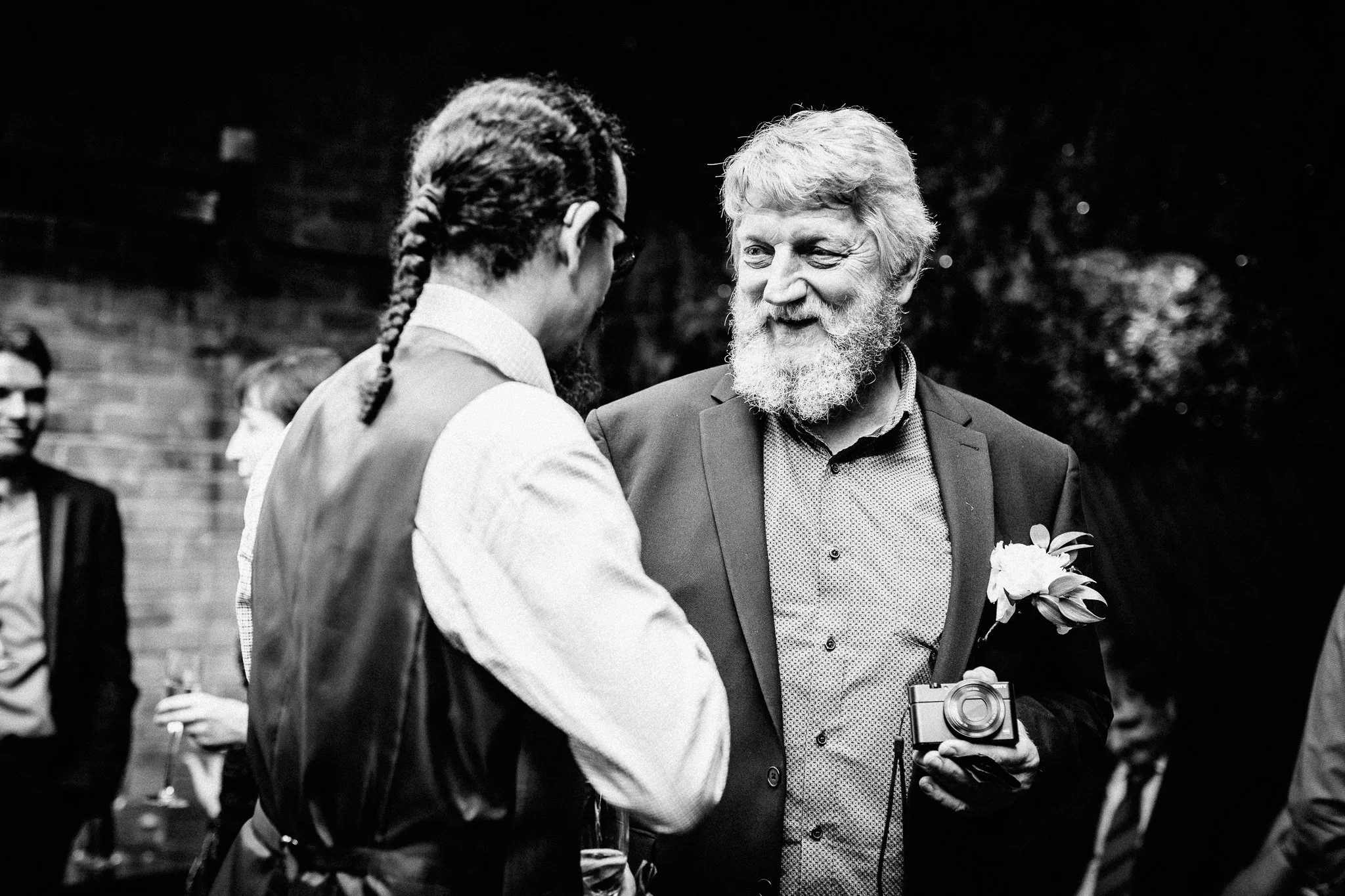  Two wedding guests speak in the courtyard area at The Truscott Arms 