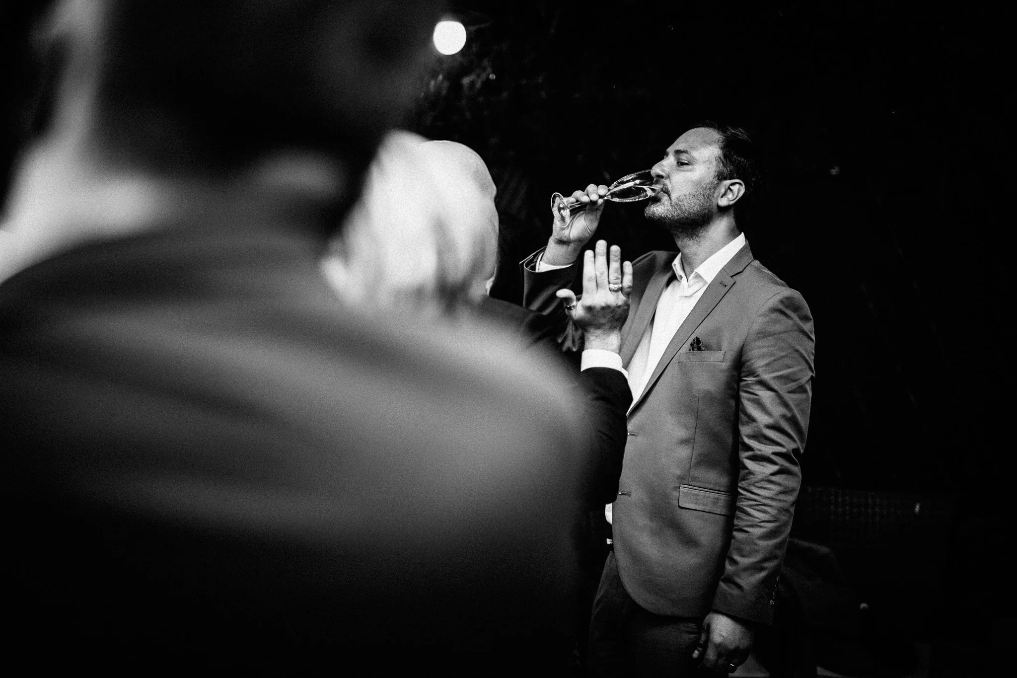  A wedding guest drinks champagne 