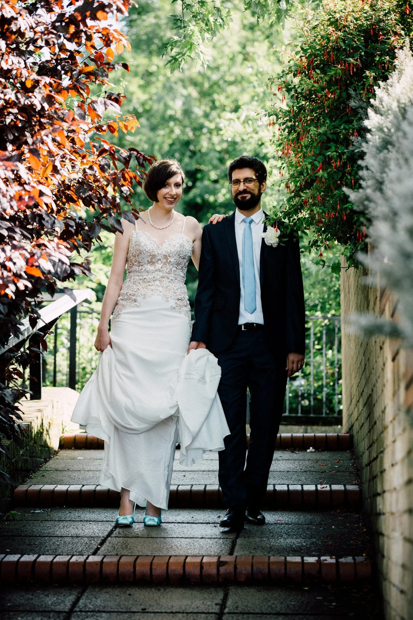  Bride and Groom walk down some steps in Maida Vale 