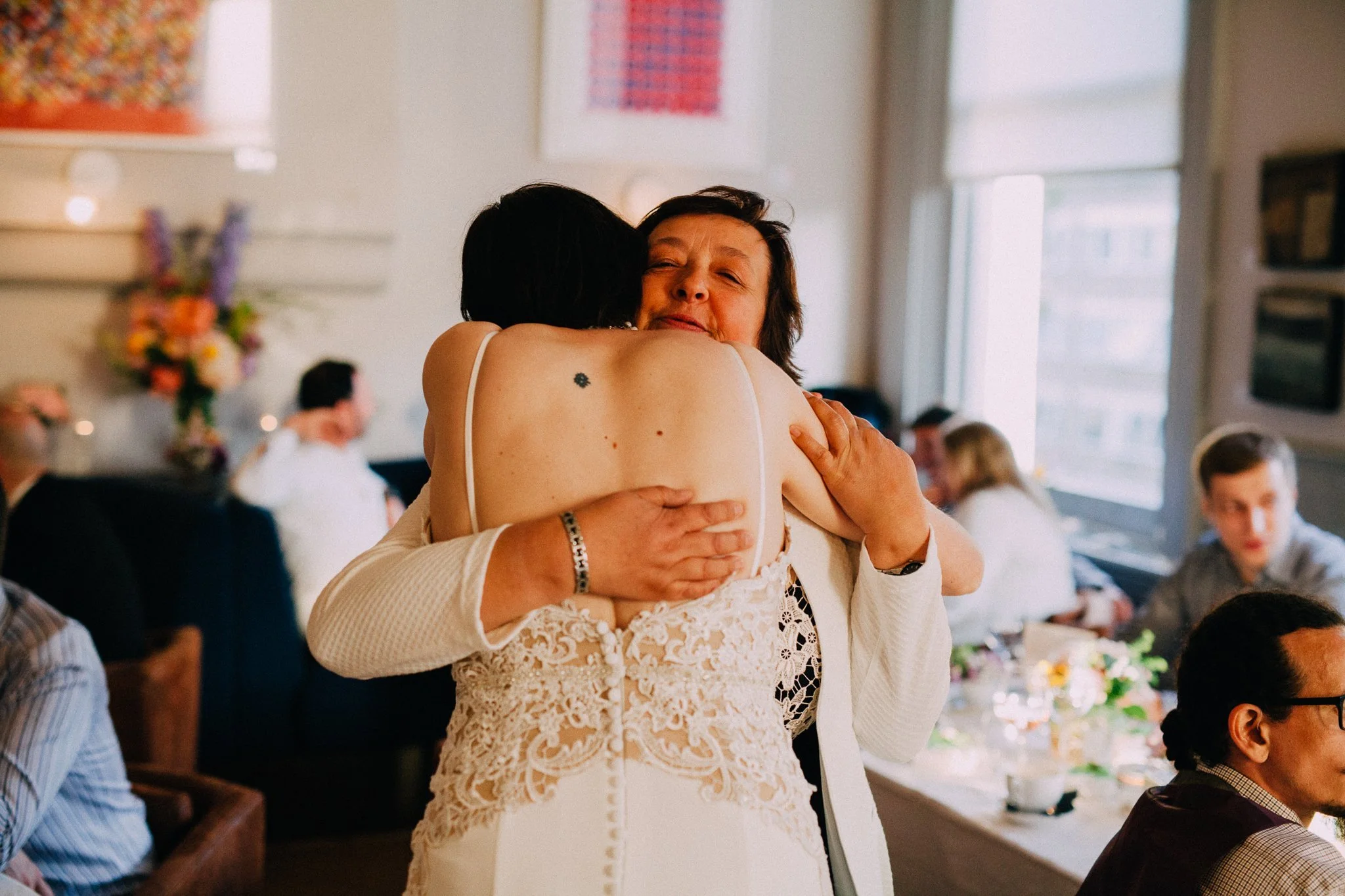  Mother of the bride hugging the bride after her speech 