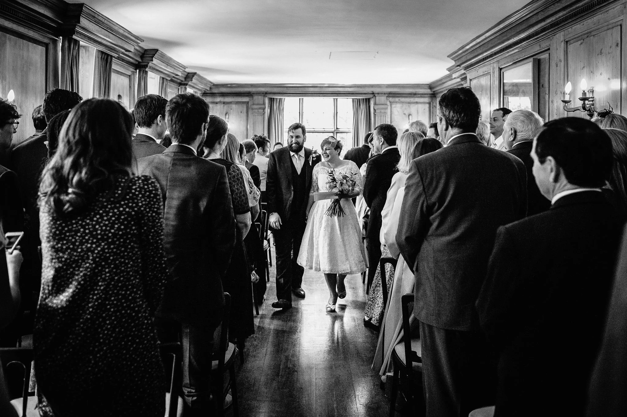  Bride and Groom walking down the aisle after being married at Burgh House Hampstead  