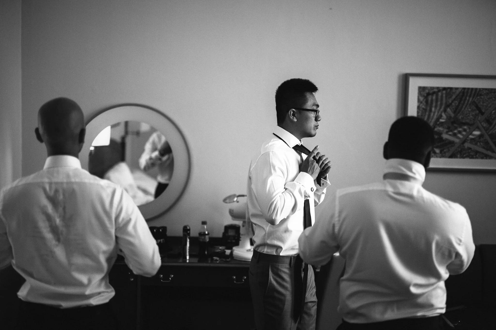 A groom and two of his ushers get ready for the wedding. 