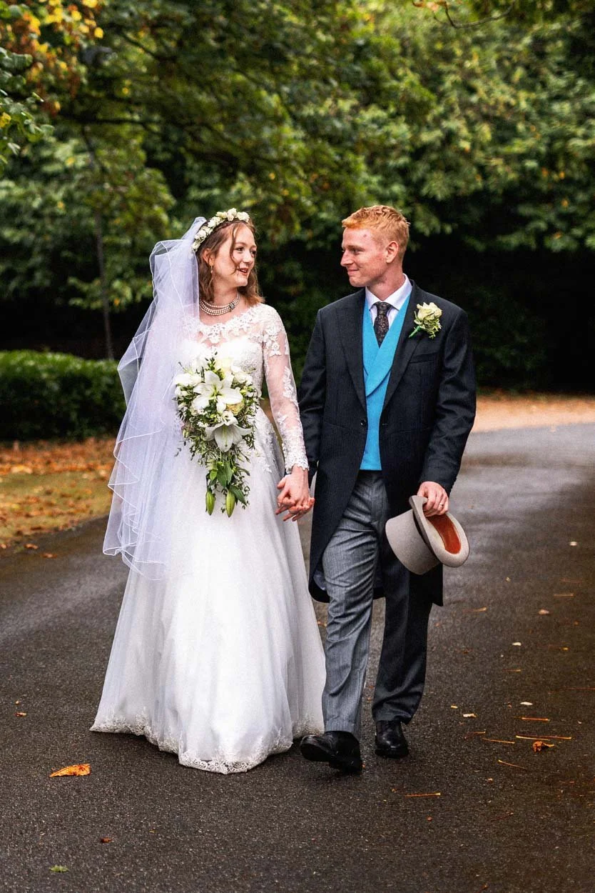 bride and groom walking after Ealing Abbey wedding