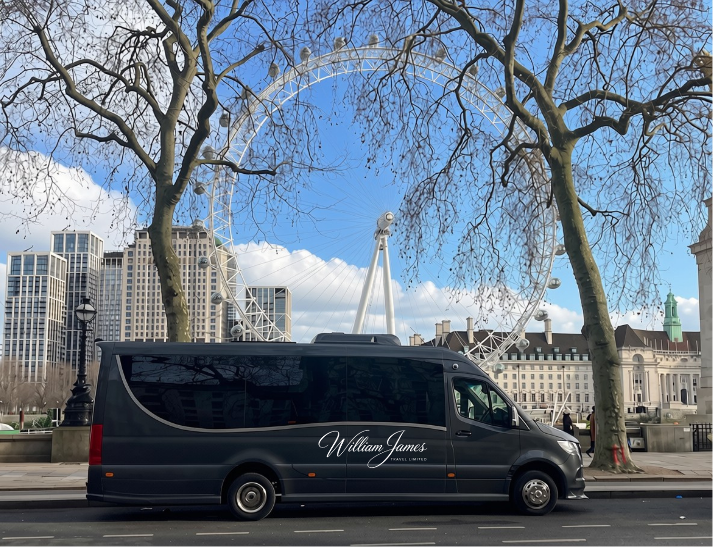 A grey William James travel minibus parked on a city street in London with tall buildings, leafless trees, and the London Eye Ferris wheel in the background.