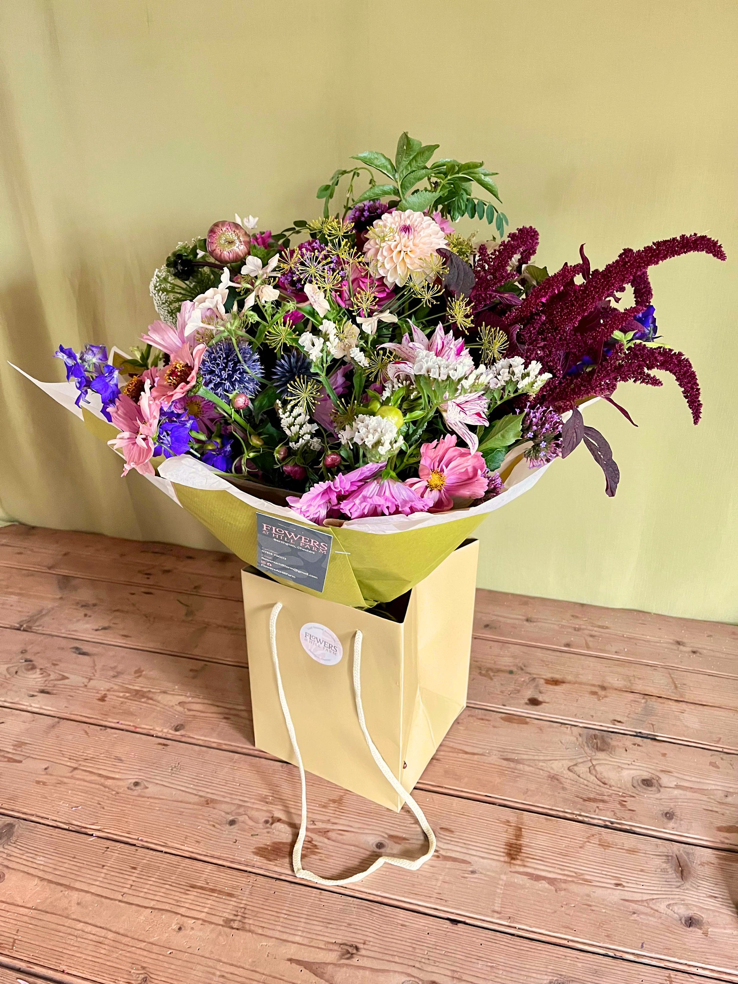 Hand tied bouquet in gift bag