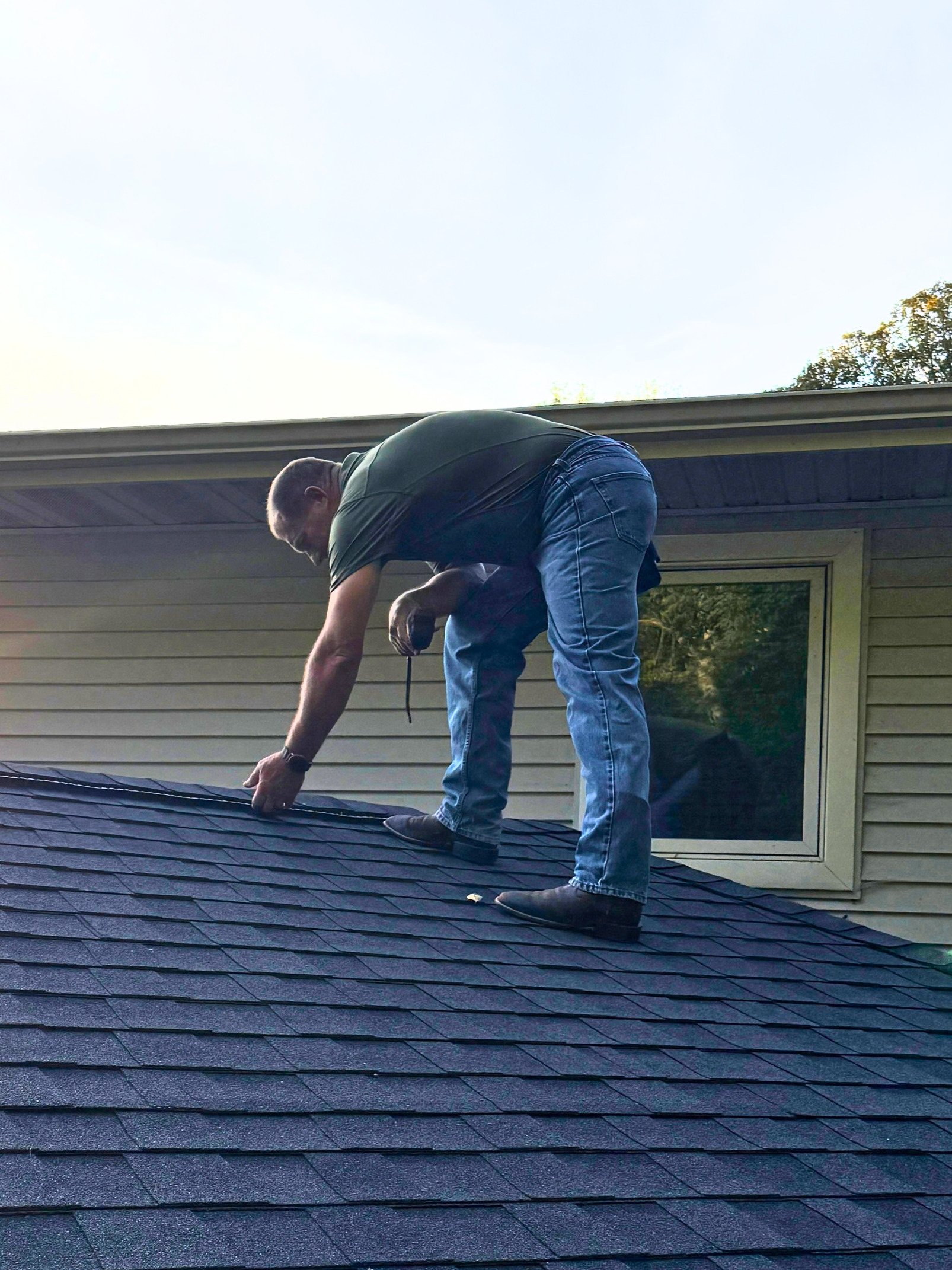 Daryl Trautmiller inspecting the roof
