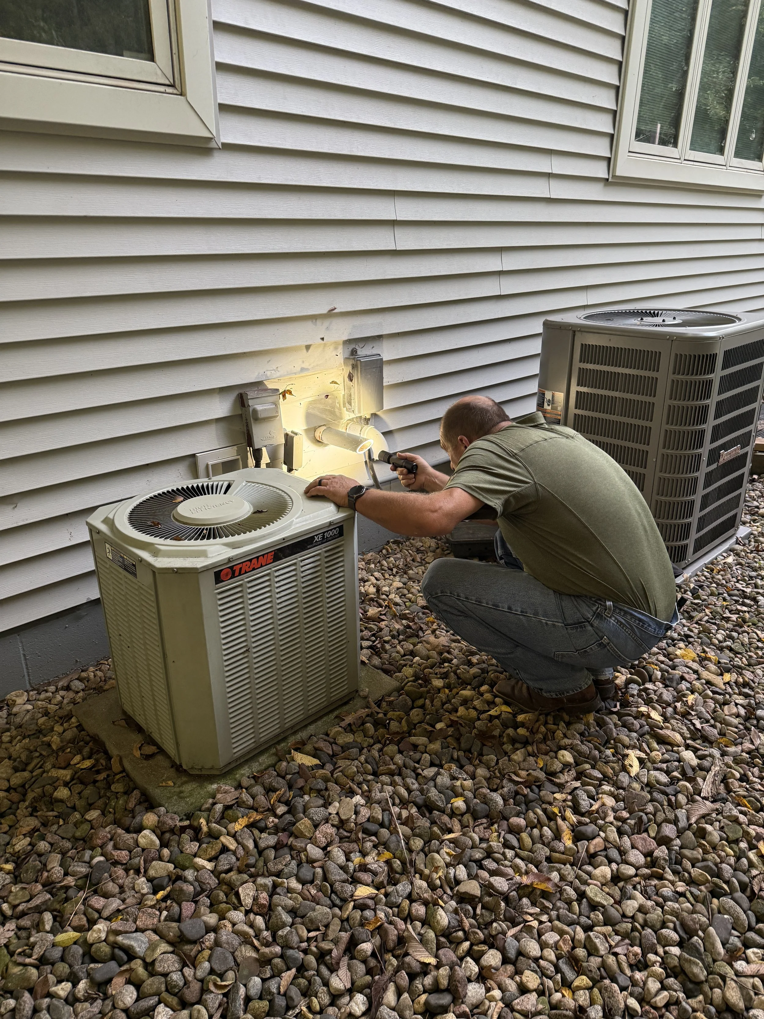 Daryl Trautmiller inspecting the intake on a house.
