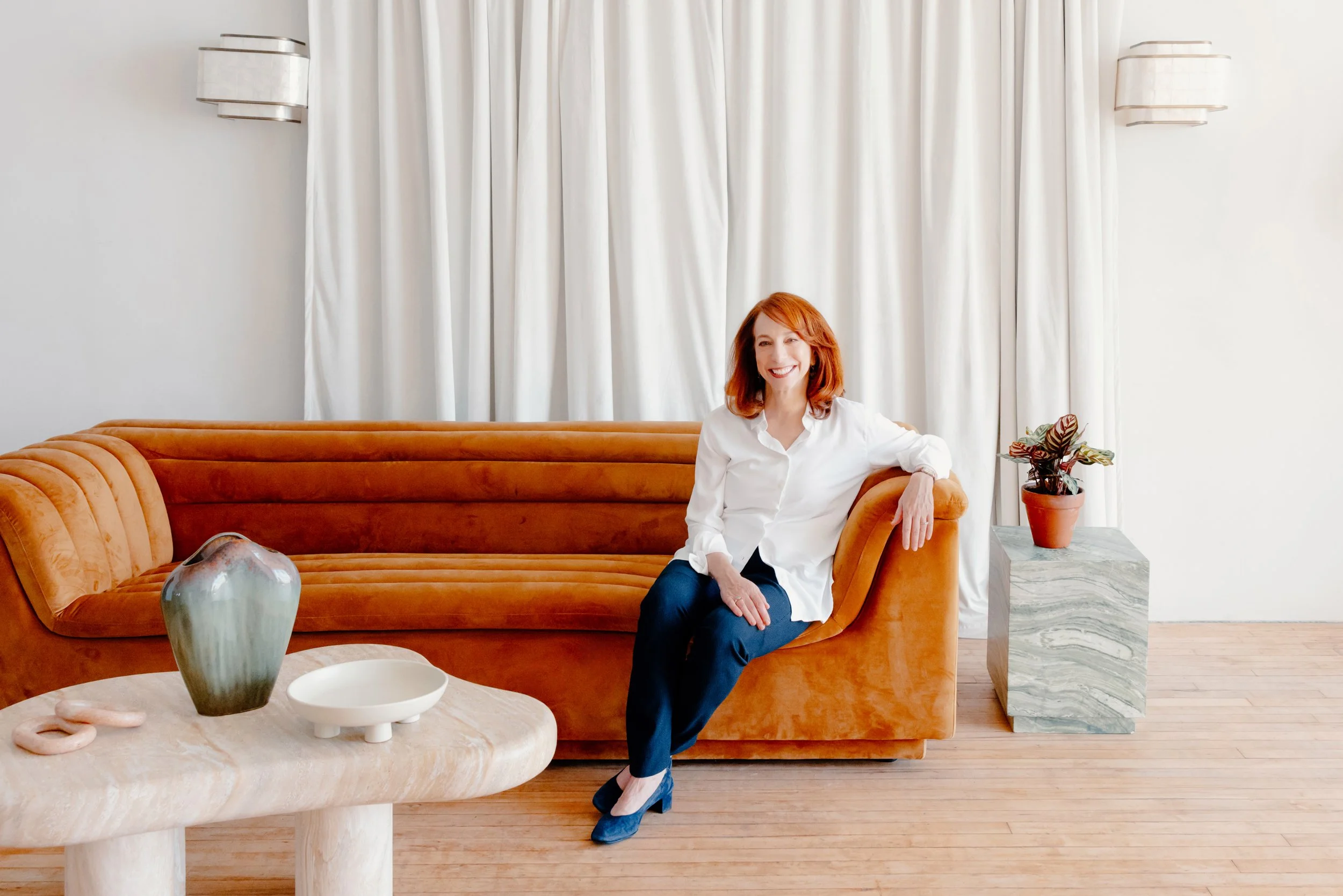 College admissions counselor Barbara Rifkind sitting on a brown velvet couch-drop-shadow