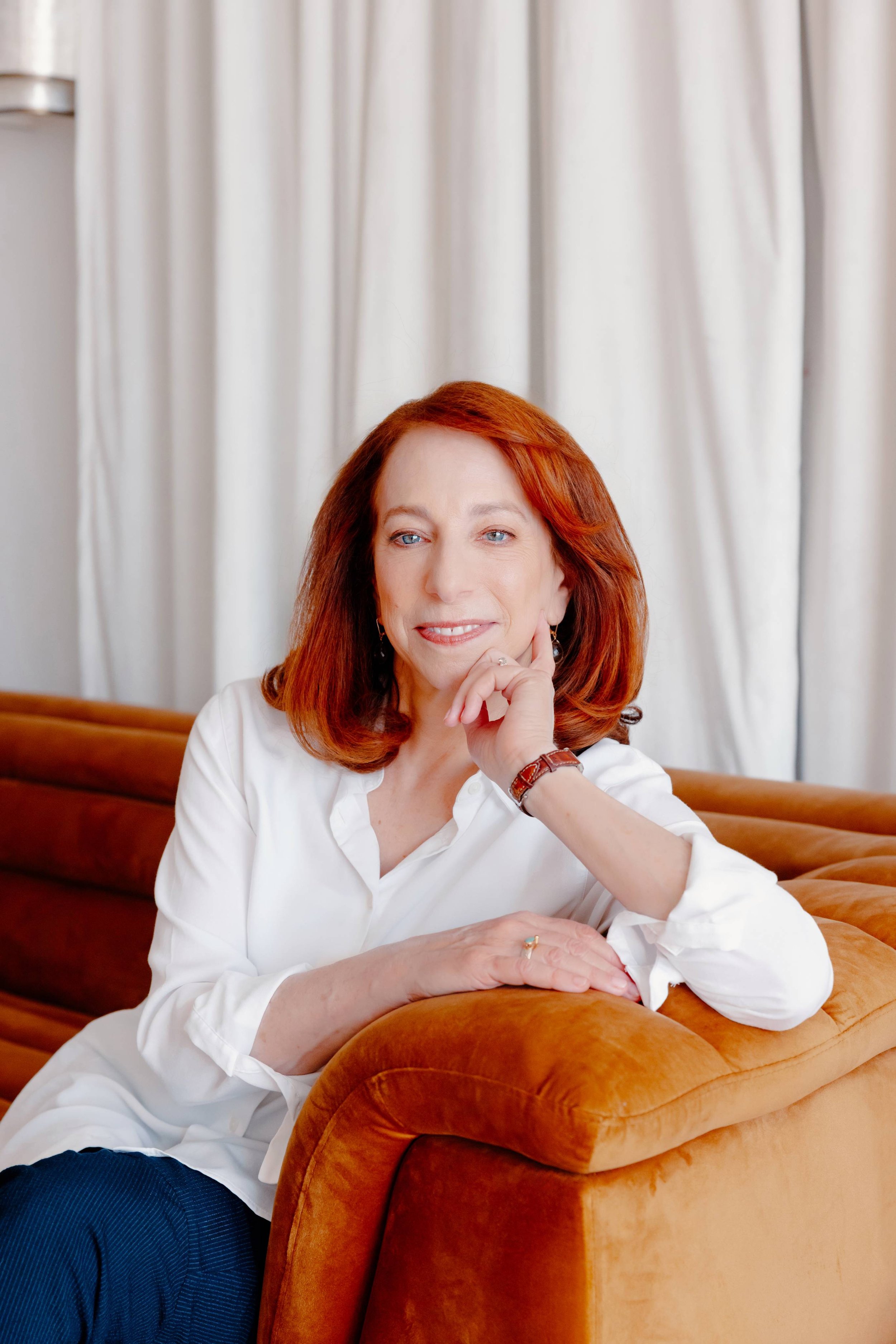 College admissions counselor Barbara Rifkind sitting on a brown velvet couch-drop-shadow
