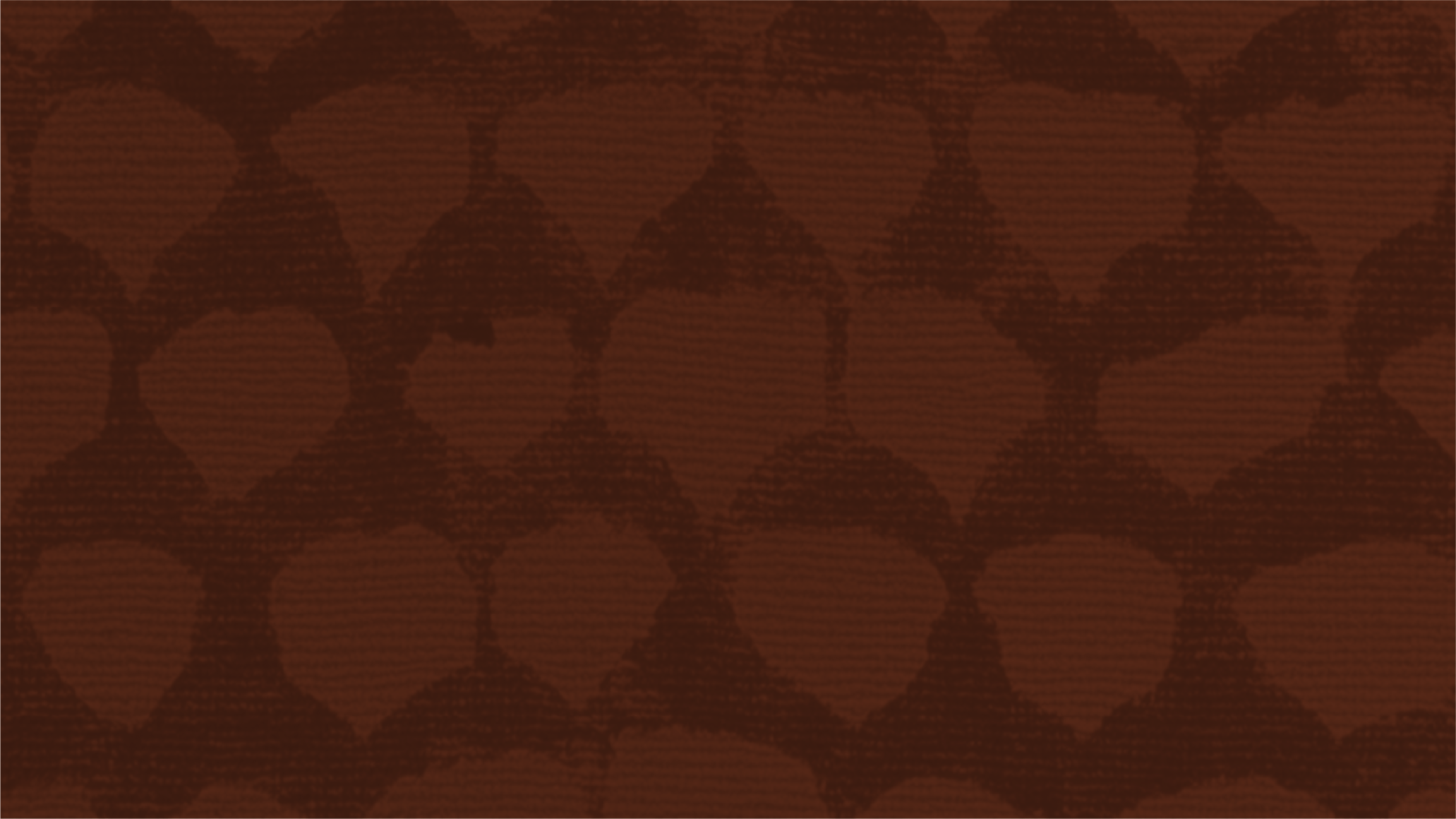 Close-up of a brown textured surface with a pattern of darker circles.