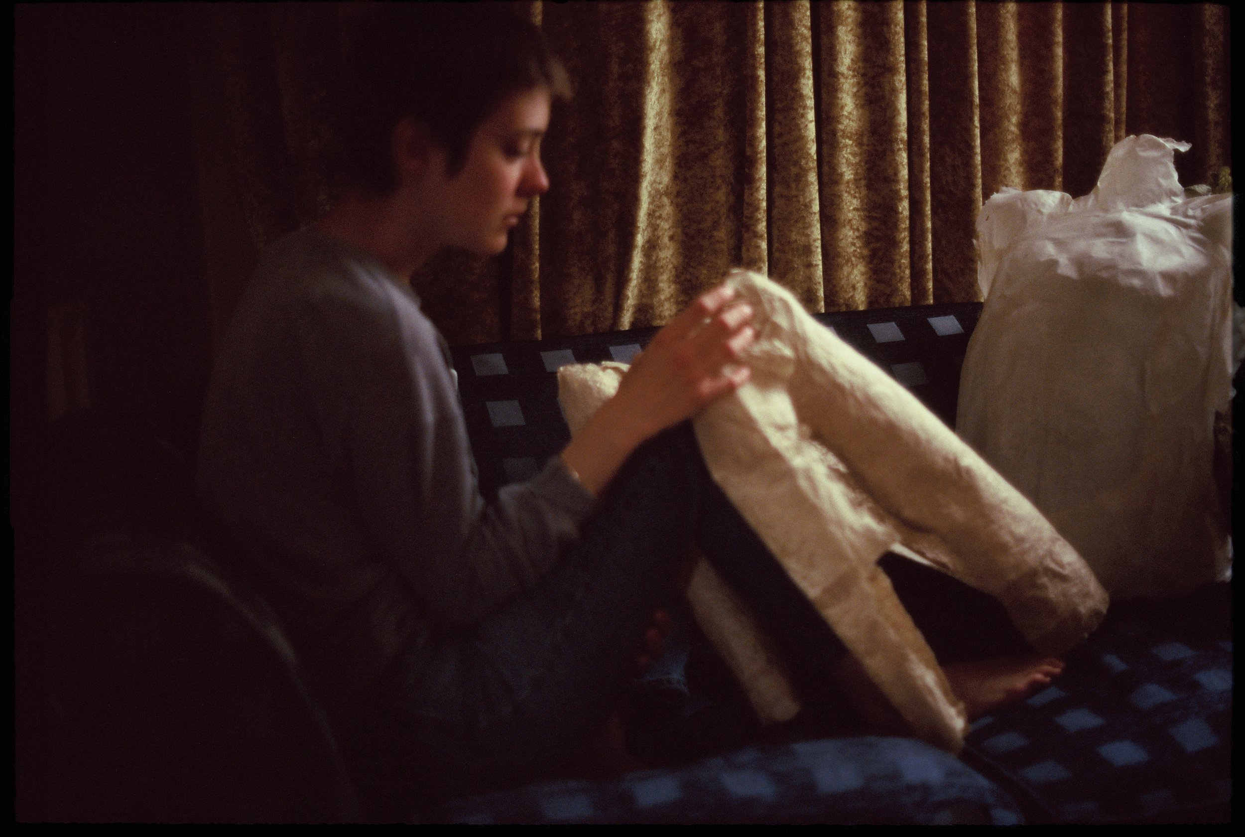 'one under each arm, steering his weightlessness', handmade-paper sculpture, 35mm slide photograph series, 2023