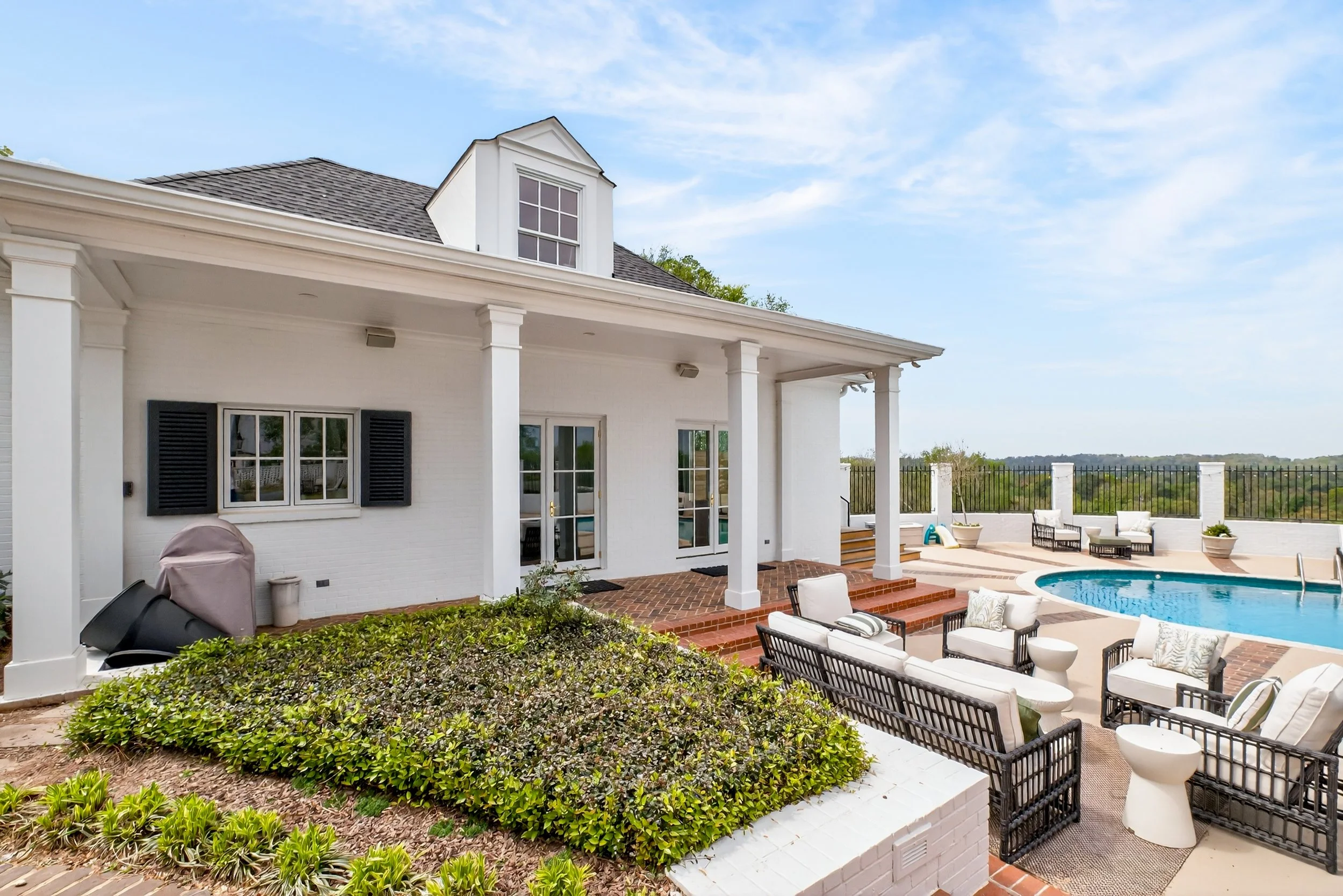 This detached two-car garage was reimagined as a custom pool house that blends recreation, comfort, and functionality. The space includes a full kitchen, dining area, living room, bathroom, and golf simulator, giving the homeowners a seamless extensi
