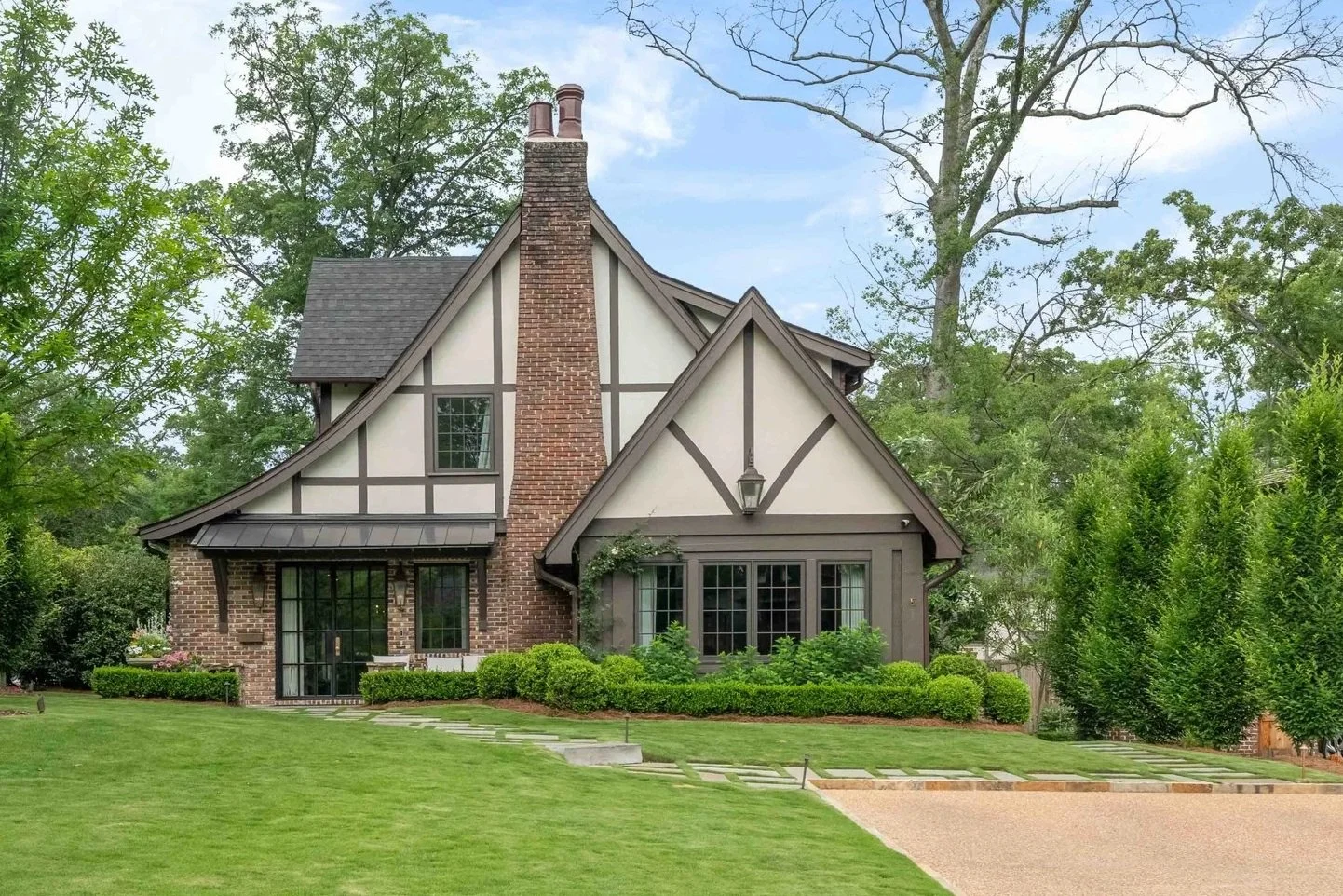 This custom home on English Circle—one of Homewood's most desirable streets—was thoughtfully designed to complement the neighborhood's classic English Tudor architecture. During the early stages of construction, the team discovered a natural undergro