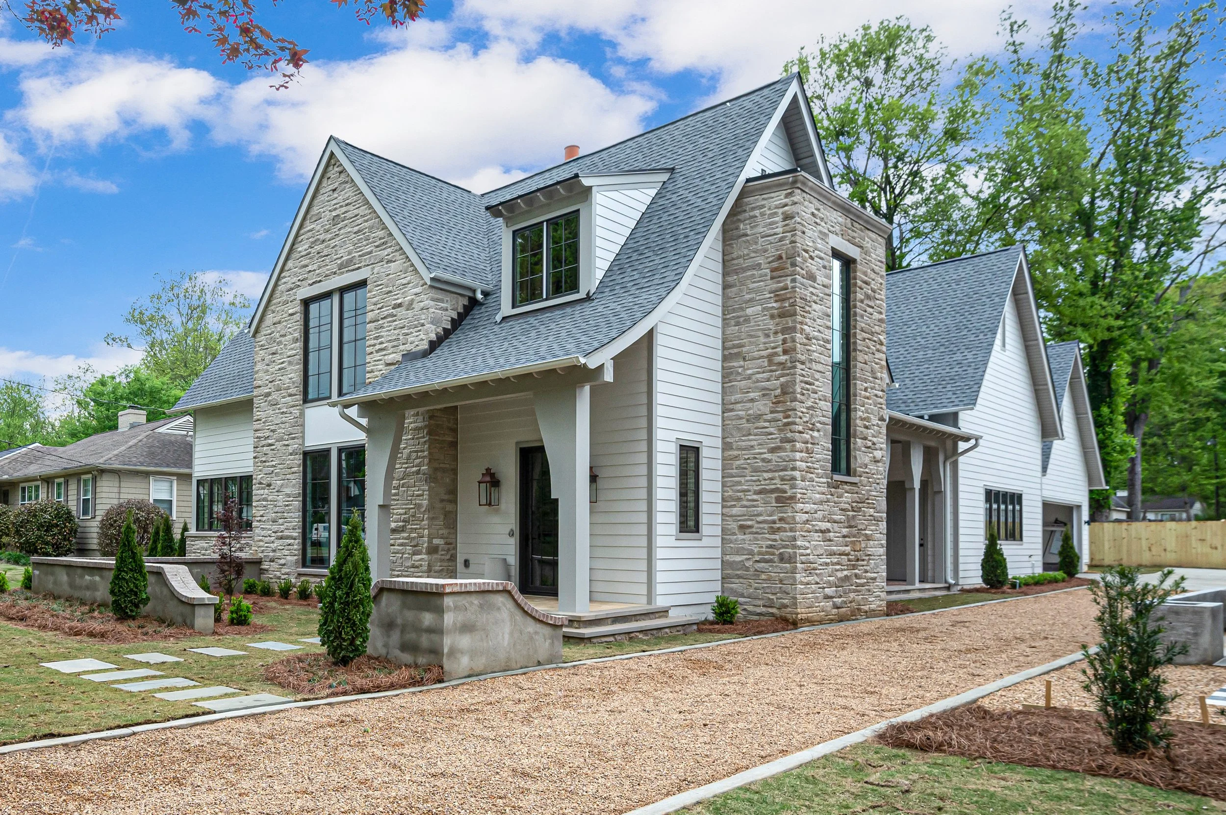 This traditional home in Mountain Brook welcomes guests through a charming front-entry courtyard and pea gravel drive. Inside, custom millwork and white oak hardwoods throughout add warmth to the home. Architect: Peer Architects