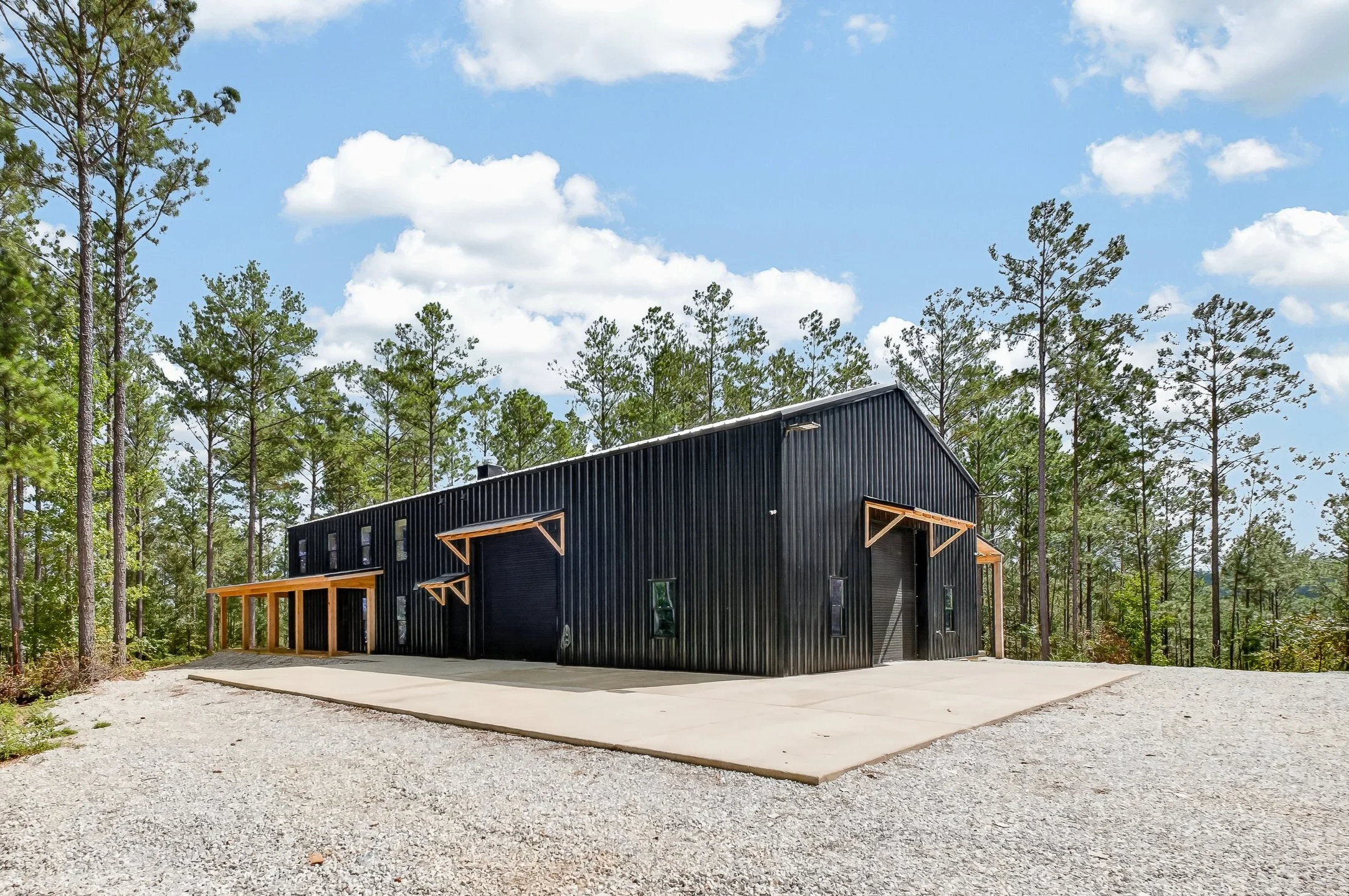 This 440-acre lakefront property sits a mile off the main road, used as a private getaway and hunting land. From the outside, it's a metal-shell structure built to look like a classic barn. The interior features modern luxury, with reclaimed lumber m