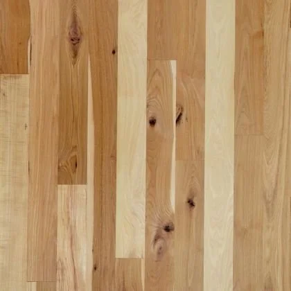 Close-up of a wooden floor with various shades of light and medium wood planks.