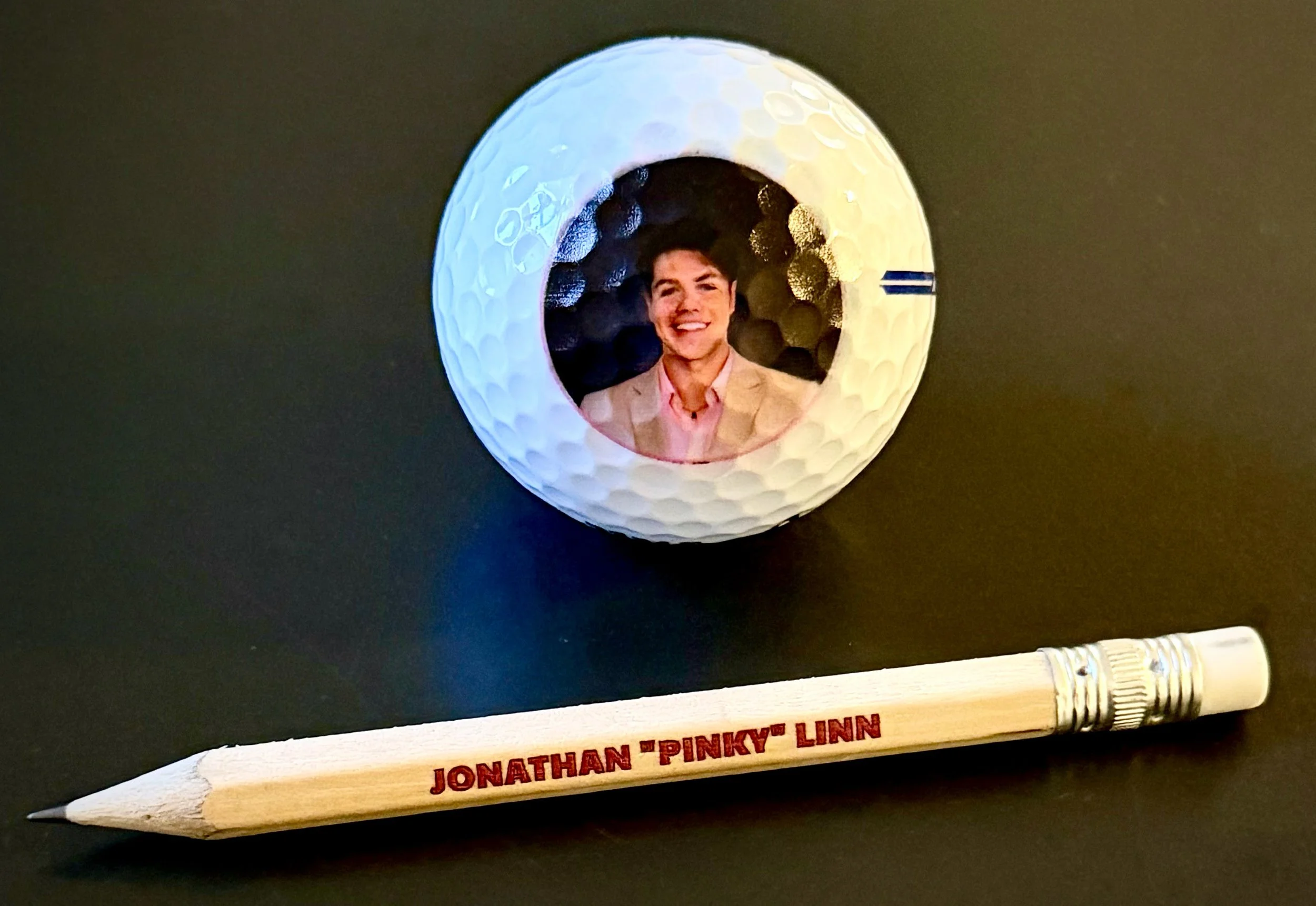 Small gifts, personal touches — custom photo golf balls and personalized pencils for memorable occasions.