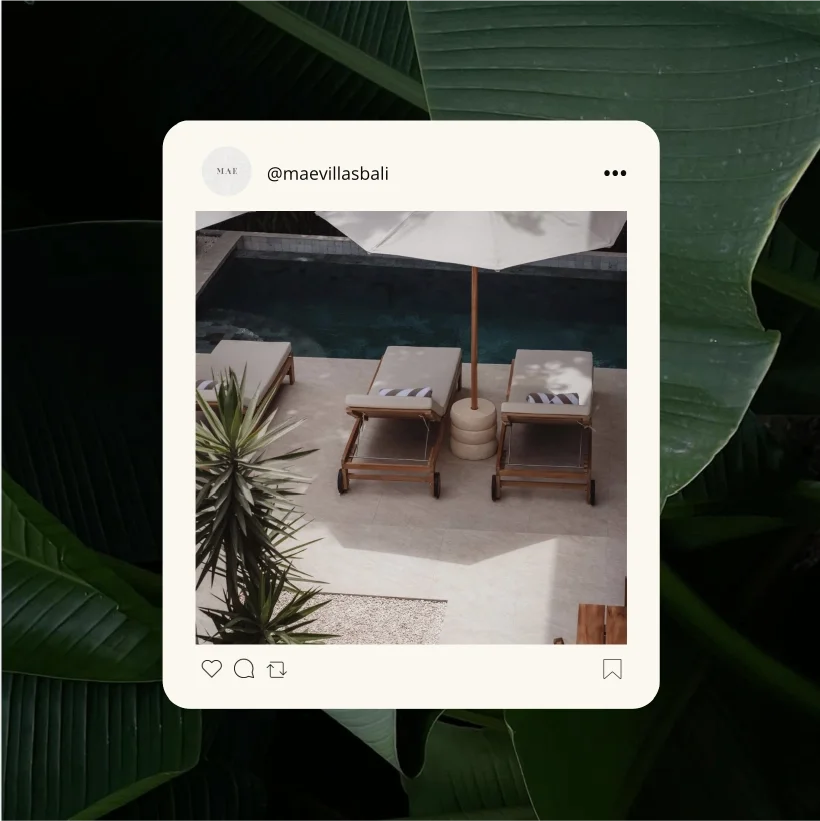 Sun loungers by the pool, with a beach umbrella and tropical plants.