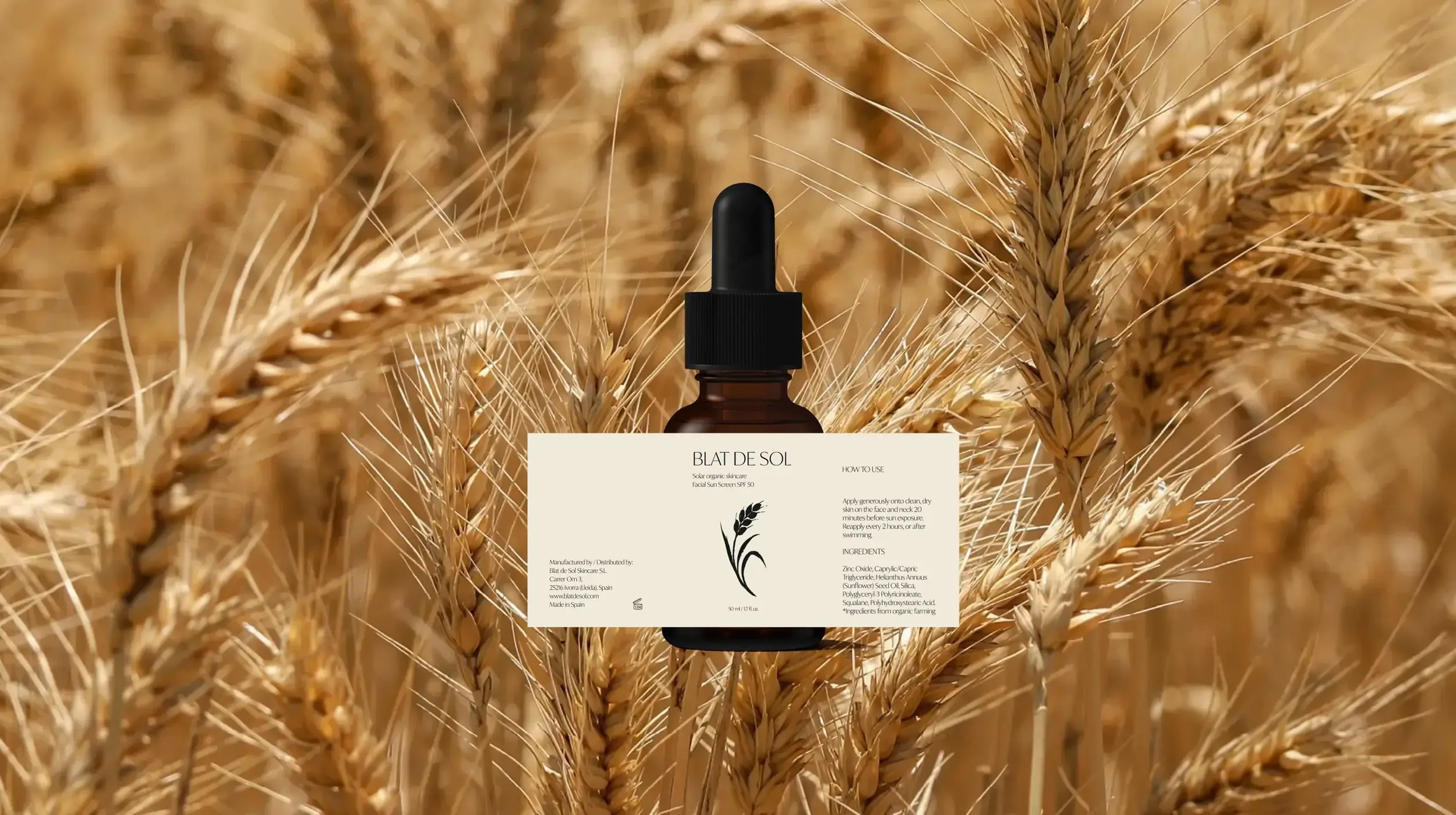 A bottle of facial serum in a field of golden wheat, with the label clearly visible that reads “Blat de Sol.”