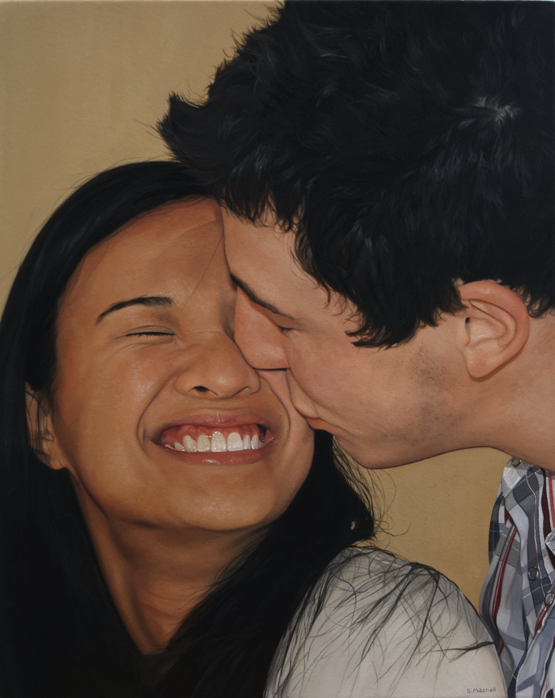 A close-up photo of a smiling woman with black hair and a man with dark hair sharing a tender moment, their faces close together, smiling and enjoying each other's company.