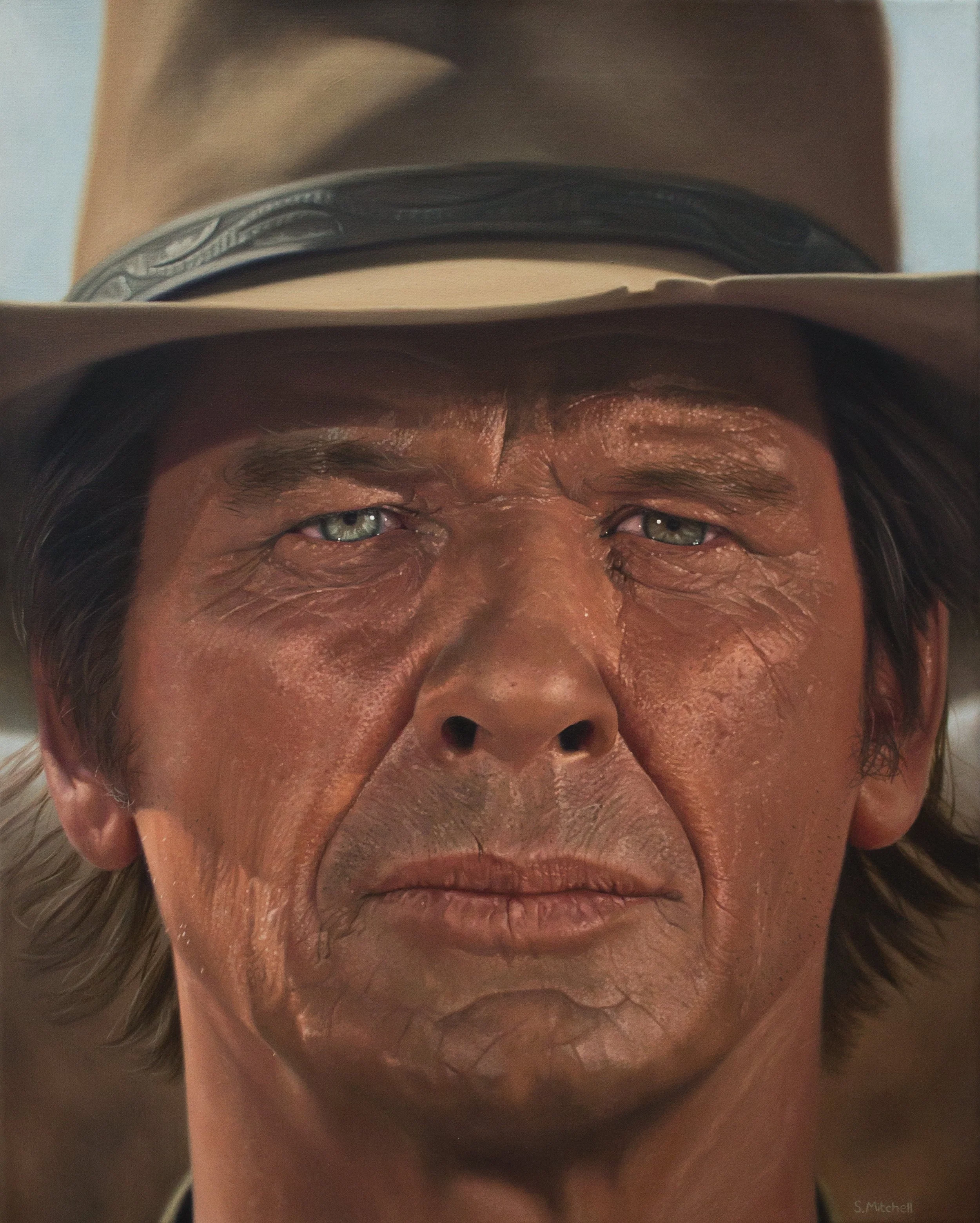 Close-up of a person's face, focusing on their forehead, eyes, nose, and mouth, with an object resting on their forehead.