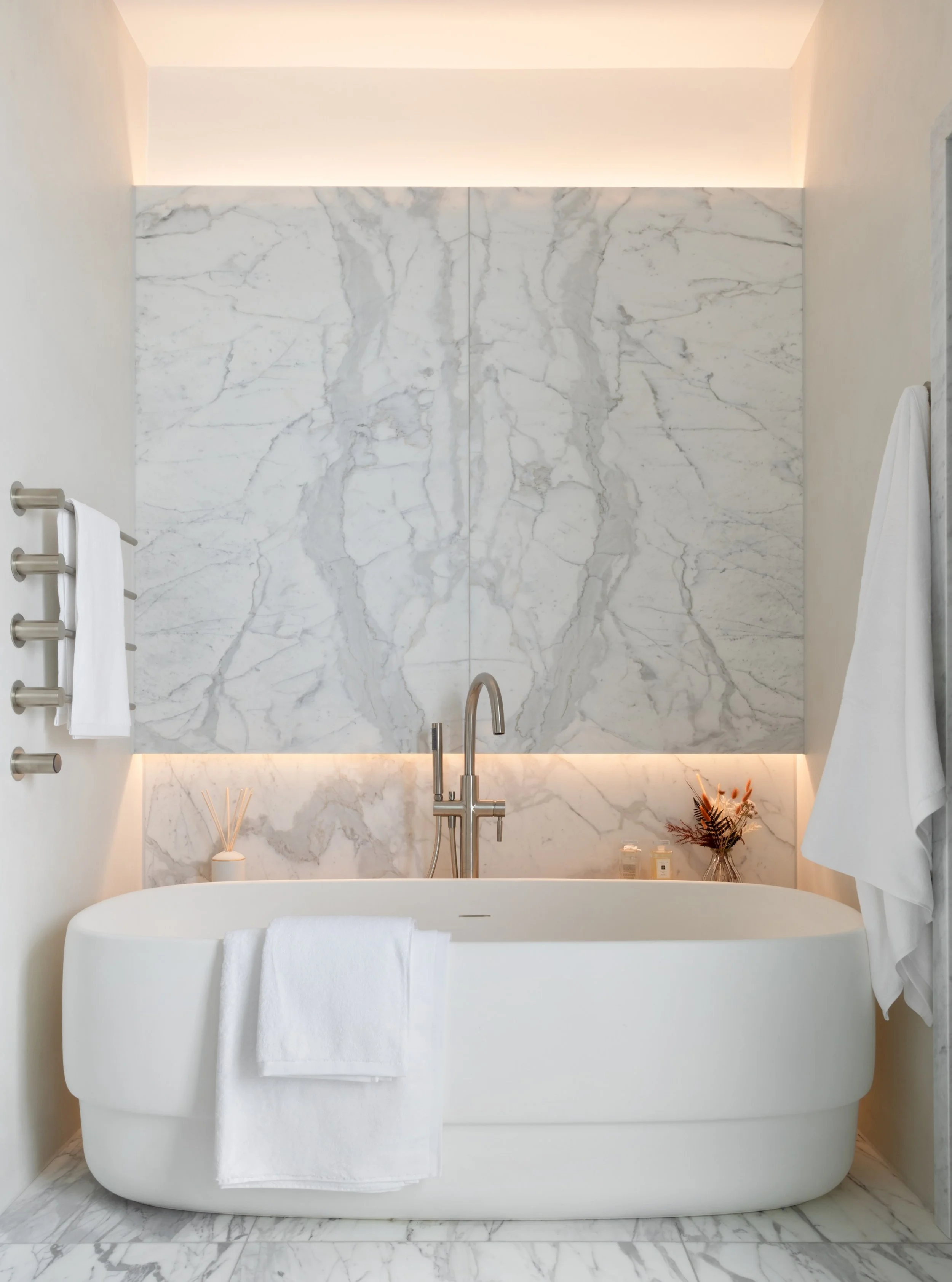 The principal bedroom en-suite and dressing room at The Lucian Home.

Designed as a calm and luxurious retreat, the en-suite centres around a generous double vanity, paired with a large bespoke mirror featuring integrated lighting for a soft, flatter