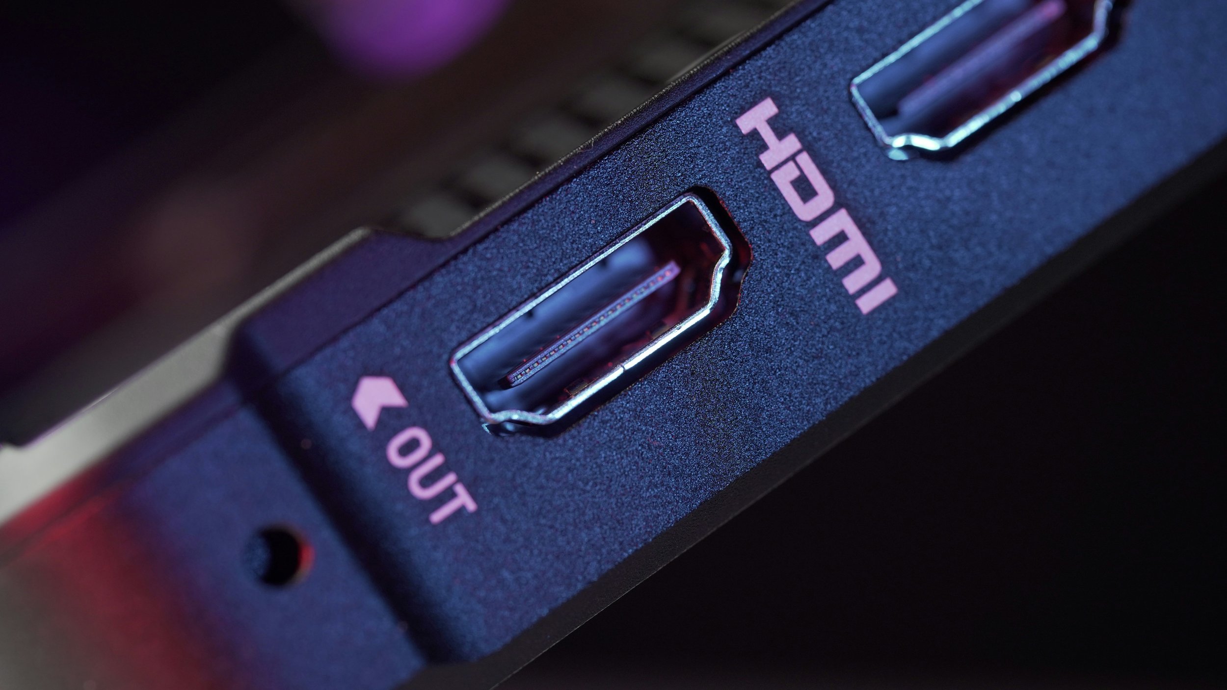 Close-up of a black computer graphics card showing HDMI and DisplayPort outputs labeled HDMI OUT