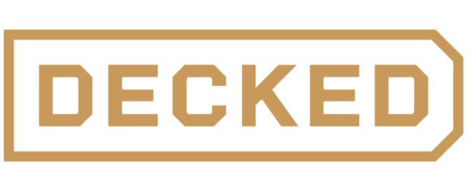 A rectangular sign with a black background and a tan border, displaying the word 'DECKED' in large tan capital letters.