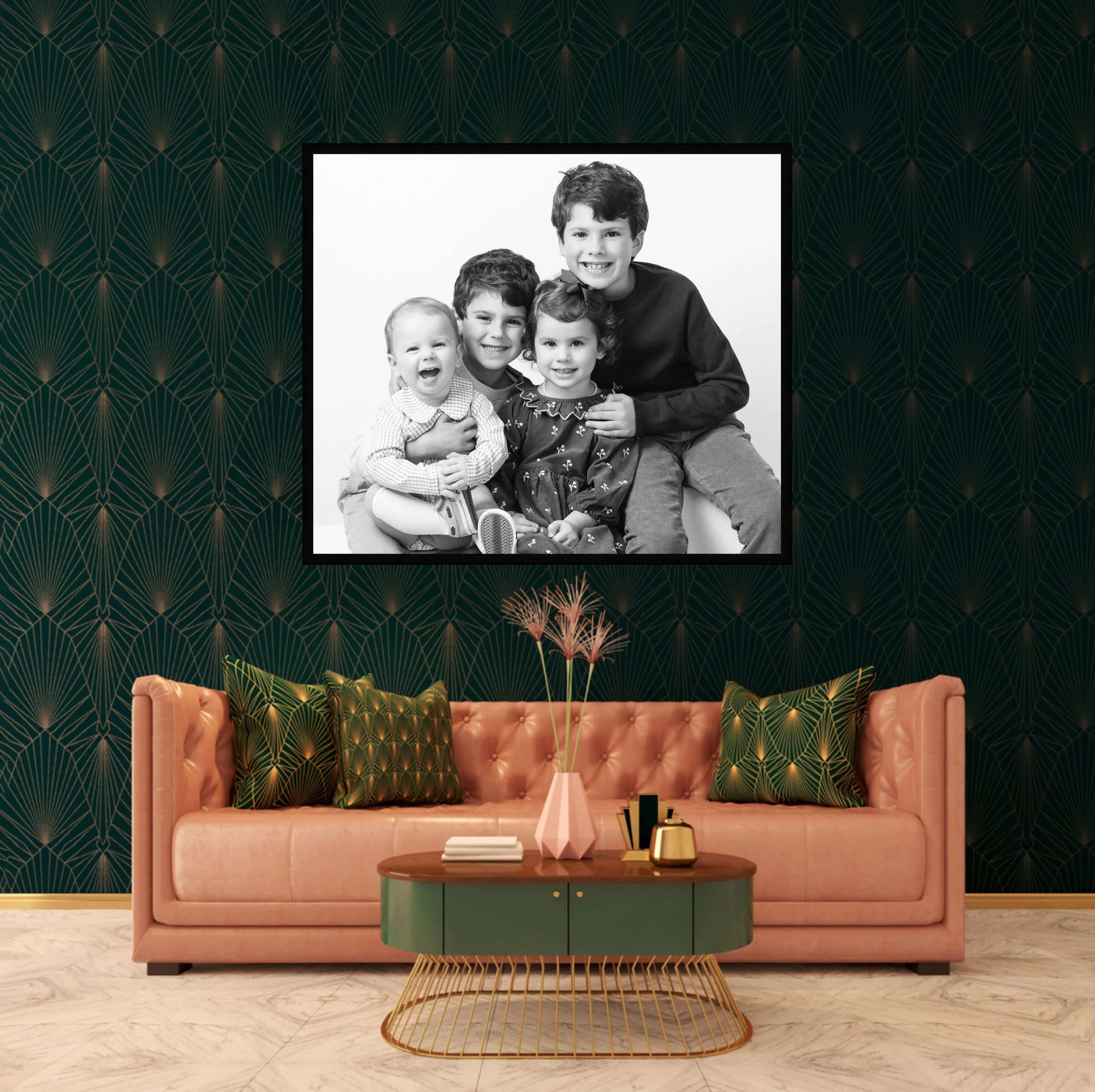 Living room with peach-colored sofa, green and gold coffee table, decorative vases, and modern wallpaper with a geometric pattern. Wall art features a black-and-white family portrait, Luxury professional branding photography in Houston Texas
