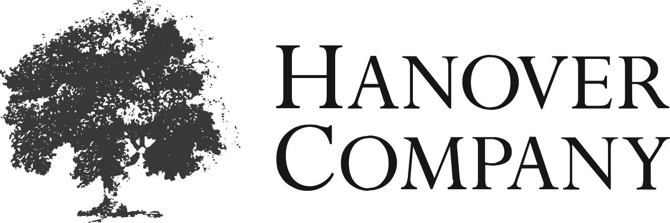 A black and white logo featuring a large tree on the left and the text 'Hanover Company' on the right.